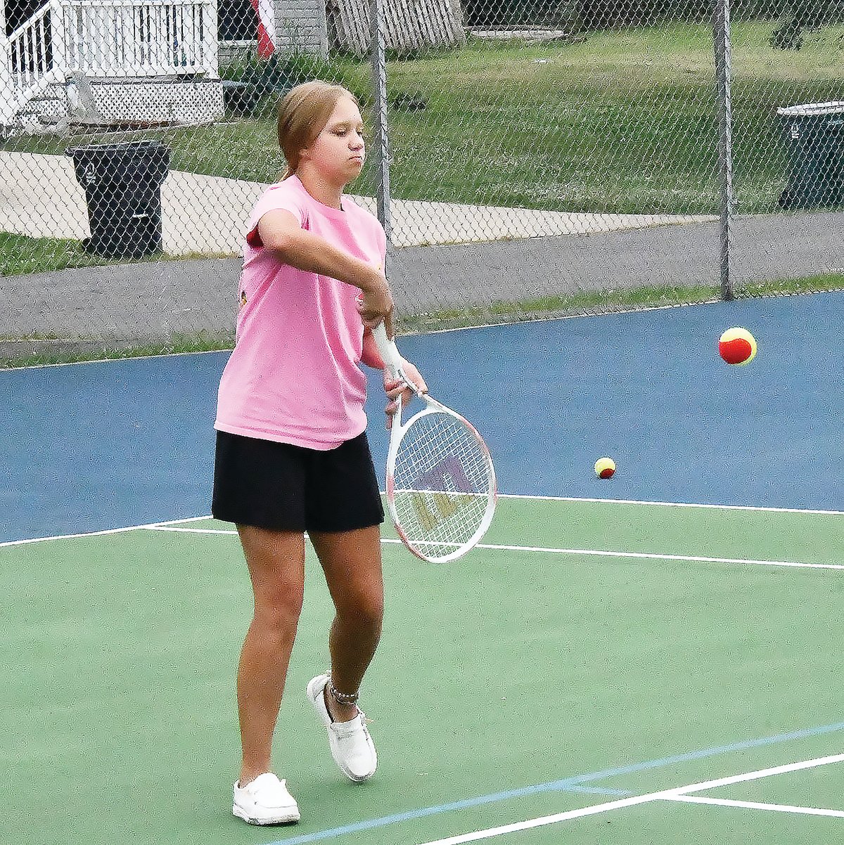 Addison Hayes returns a shot from tennis instructor Hallie Kroner during tennis lessons on Friday, June 24.