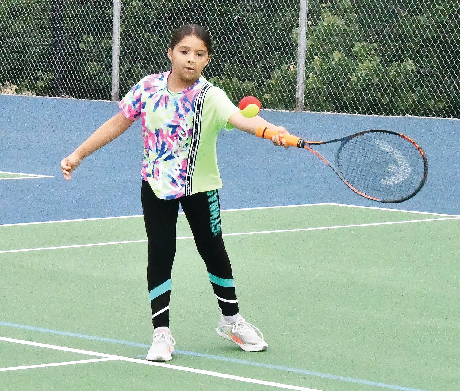 Tabitha Rodriguez uses a forehand stroke during tennis lessons on Friday, June 24, at Shelter One Courts. About one dozen children participated in lessons this June.