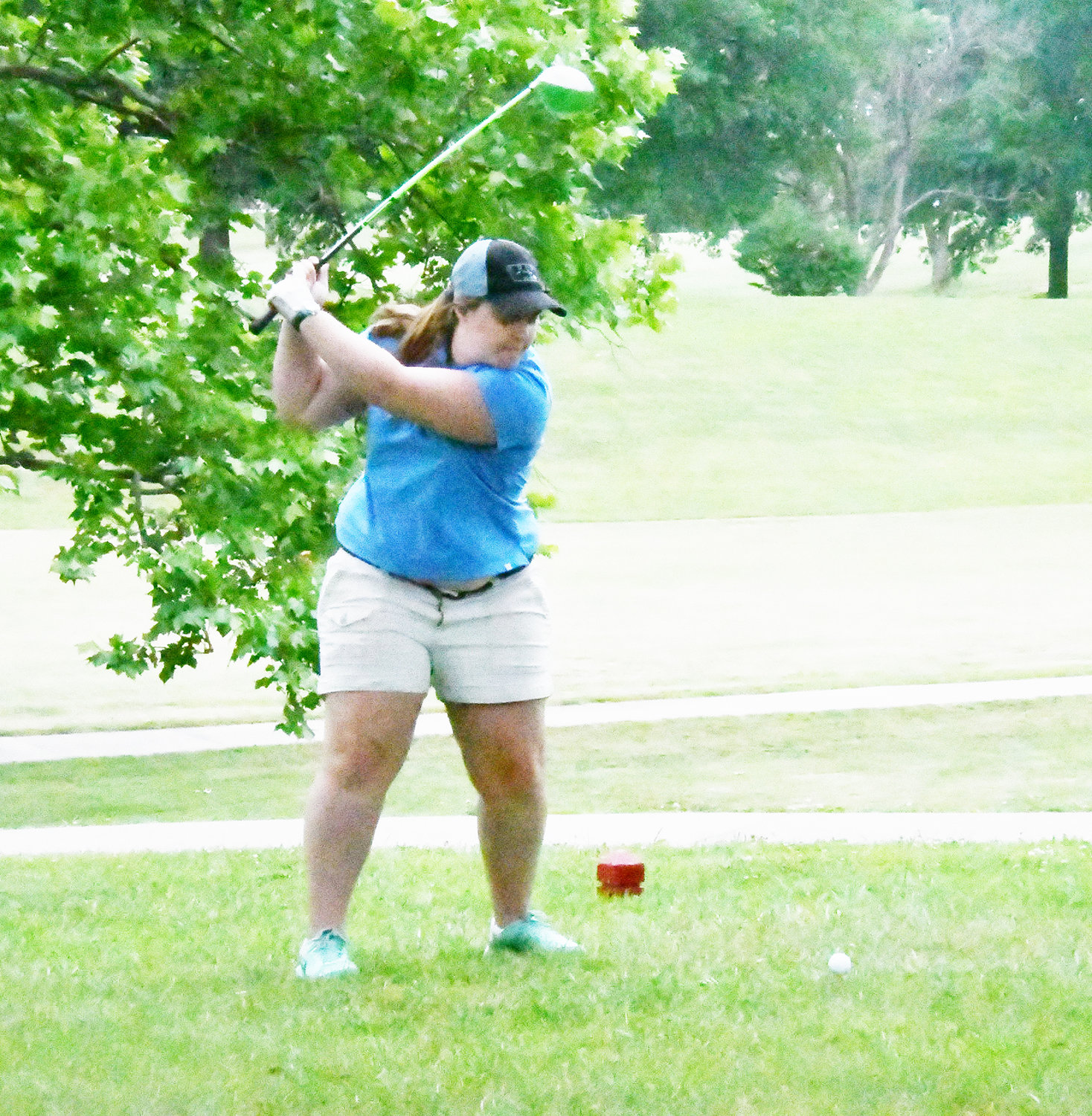 Anna Campbell prepares to hit her driver from the red tees at the Moberly Spartan Booster Club tournament.