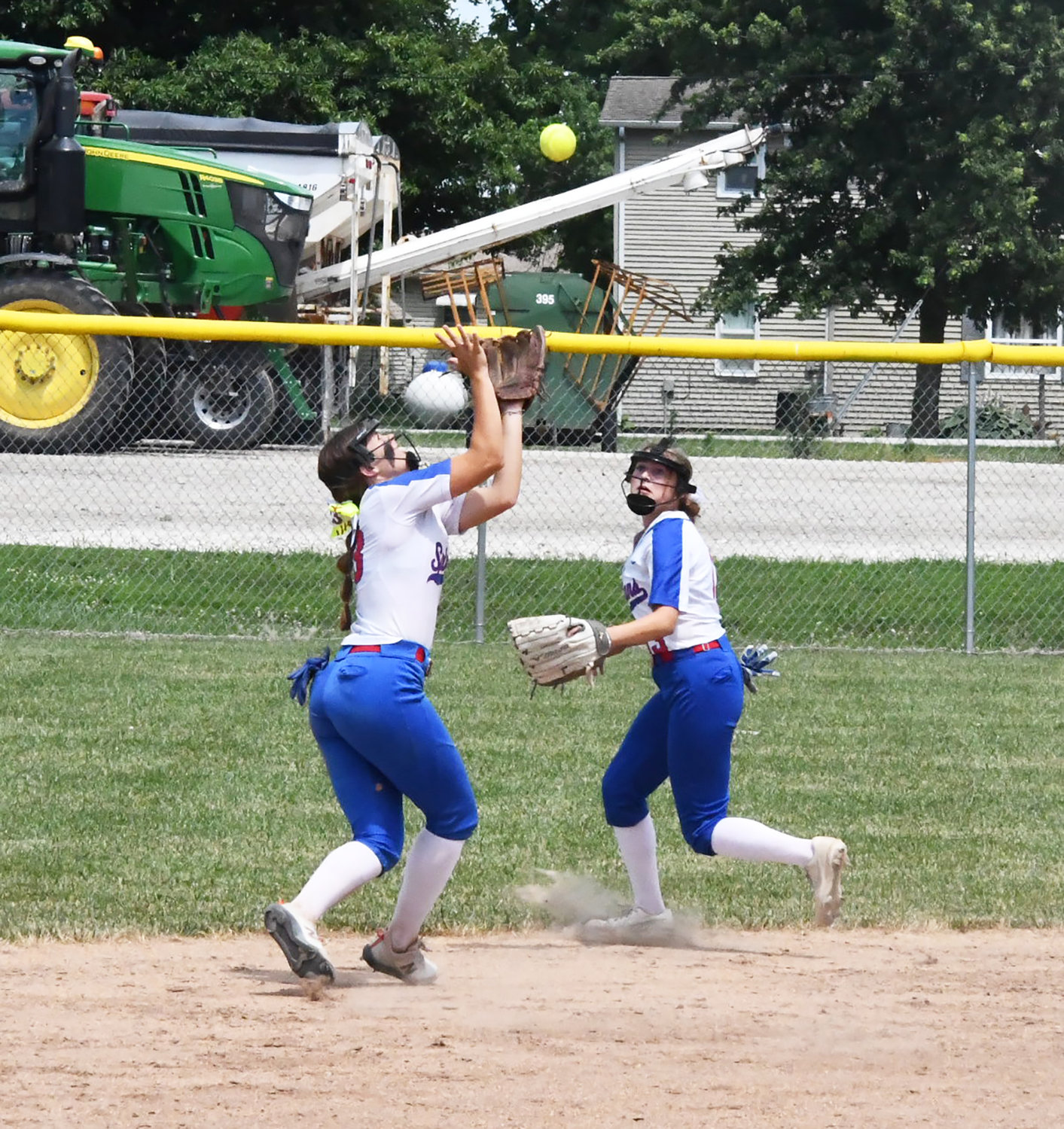 Moberly shortstop Kennedy Messer, left, records the putout while Elizabeth Reisenauer backs up the play.