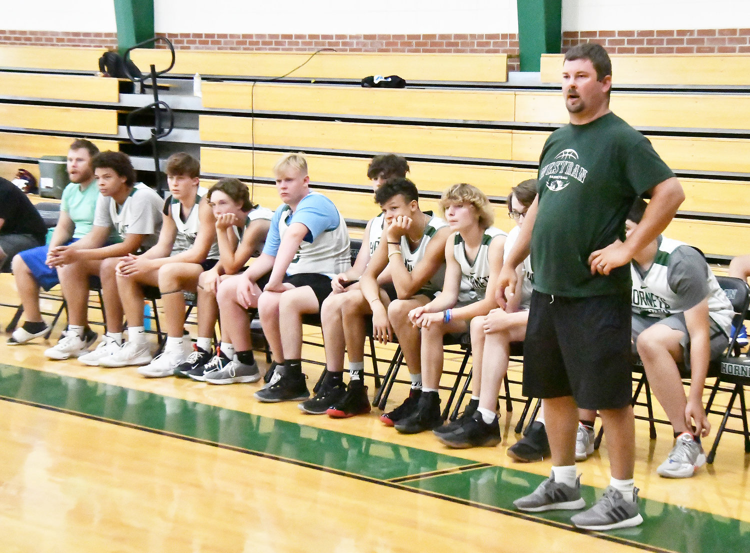 Westran head boys' basketball coach Chris Sander and the bench look on during a scrimmage versus Van-Far.