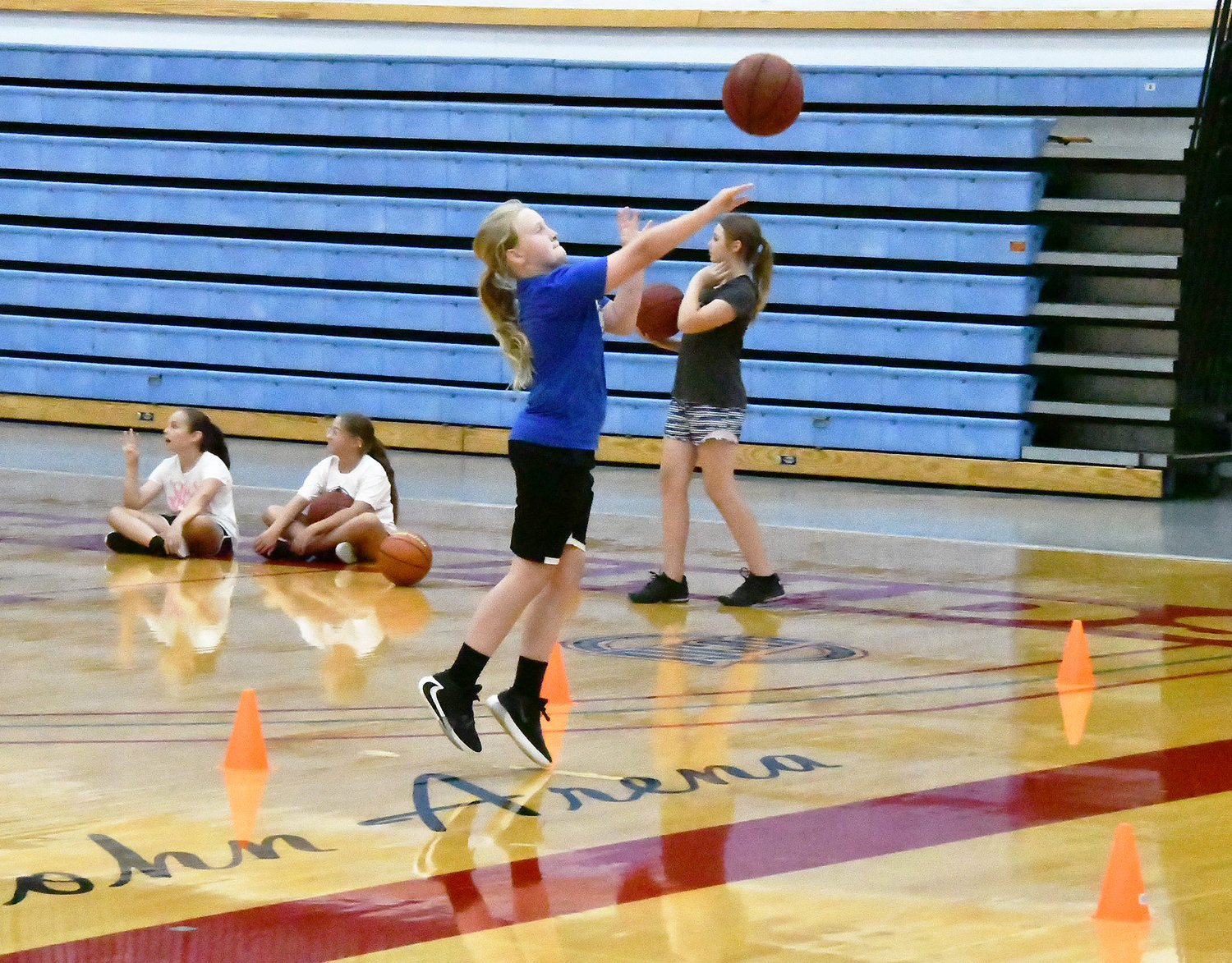 Cones were set up on the floor for shooting drills, with Berklee Taylor attempting a shot here.