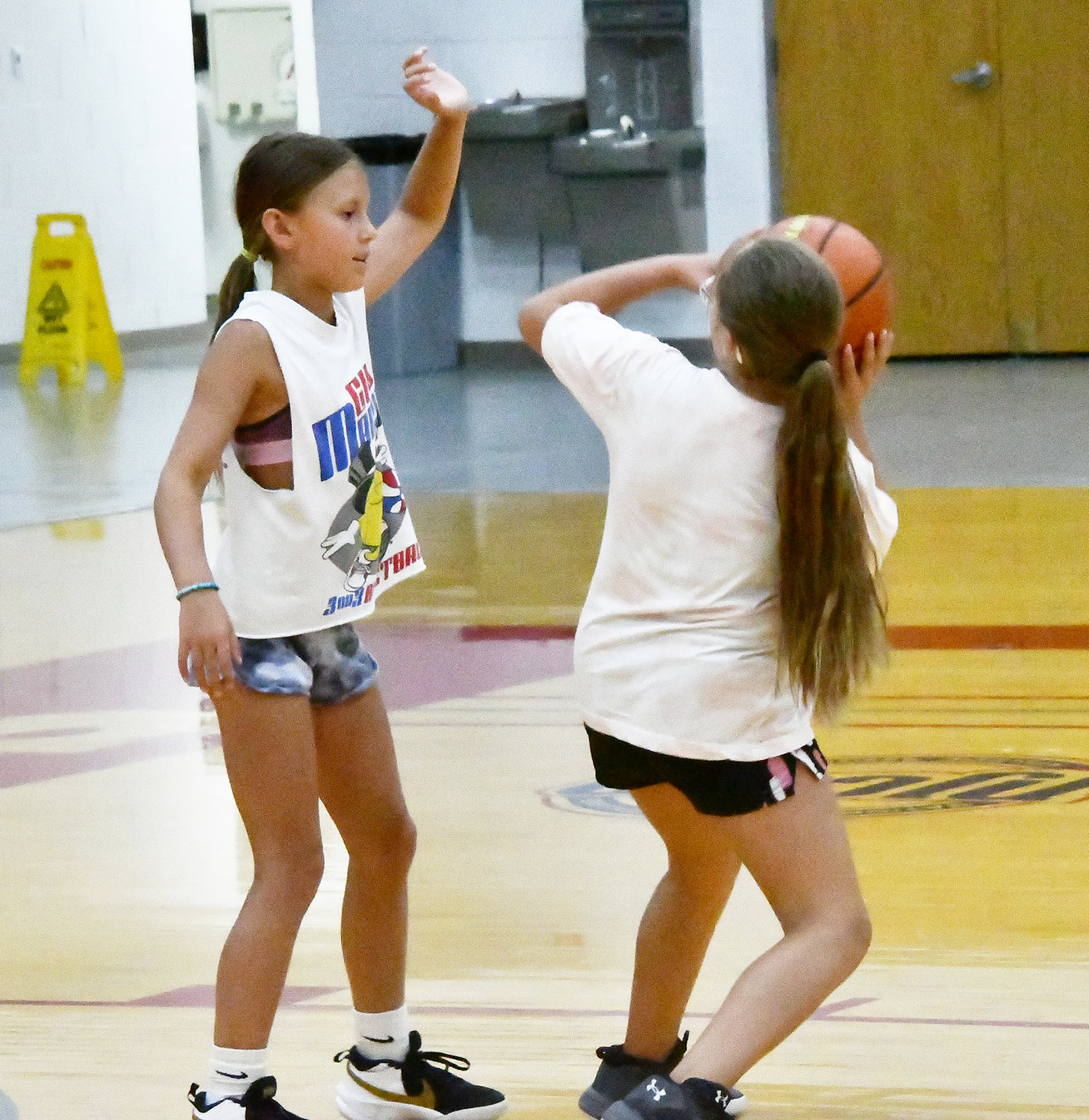 Ally Scott tries to shoot while Brelee David defends during a one-on-one game.