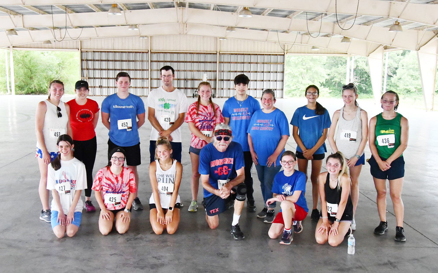 Moberly High School runners past and present competed in the Independence Day 5K run, gathering for a photo after the race inside Riley Pavilion.