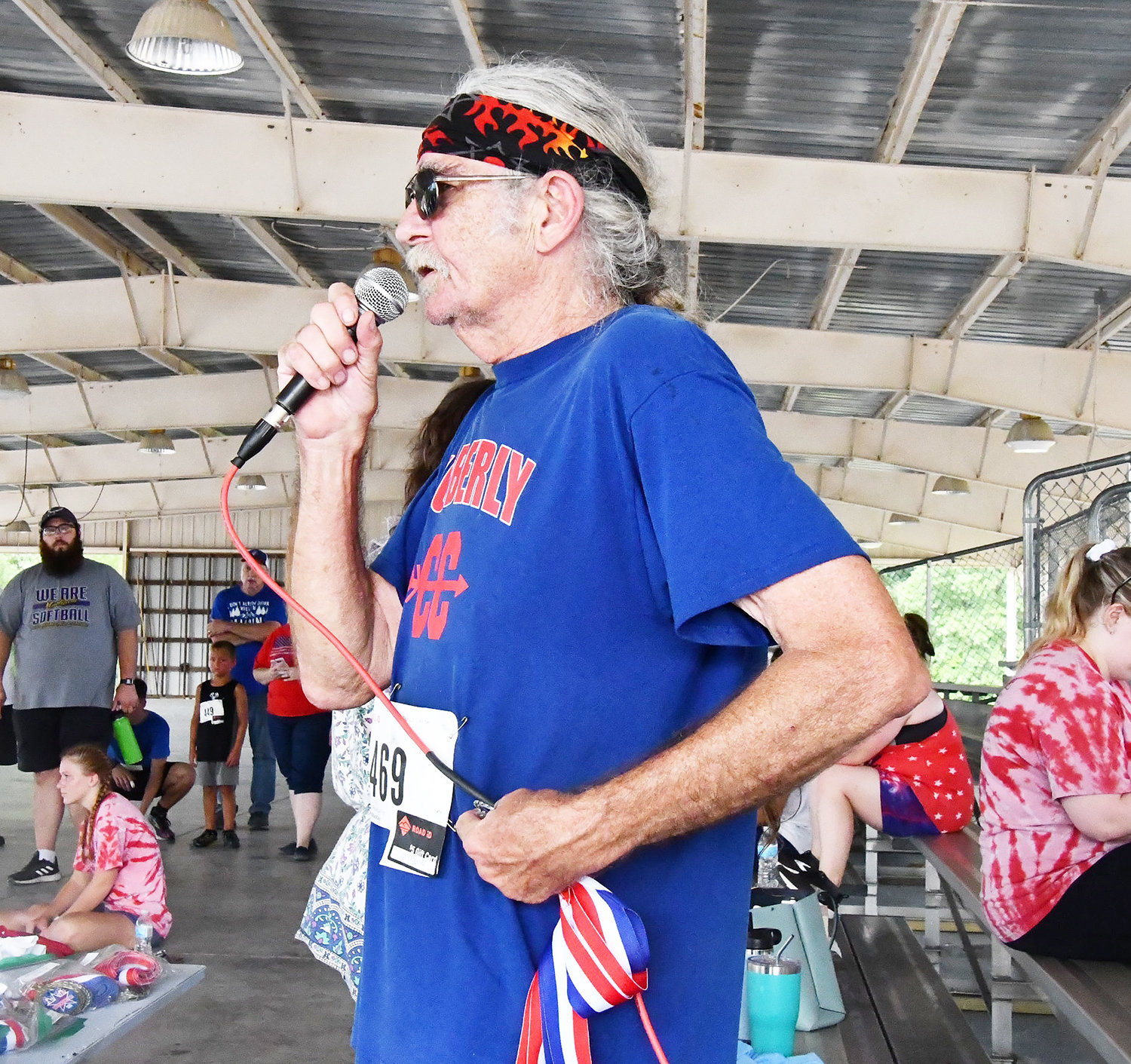 Independence Day 5K run organizer Gregory Carroll, also the Moberly High School cross country coach, talks to the crowd after the race.