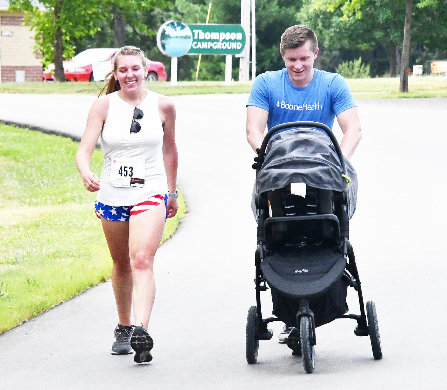 Alaina Downing and Colton Downing walk toward the finish, with baby Knox in the stroller. Colton Downing was a distance runner at the University of Central Missouri in the 2010s.
