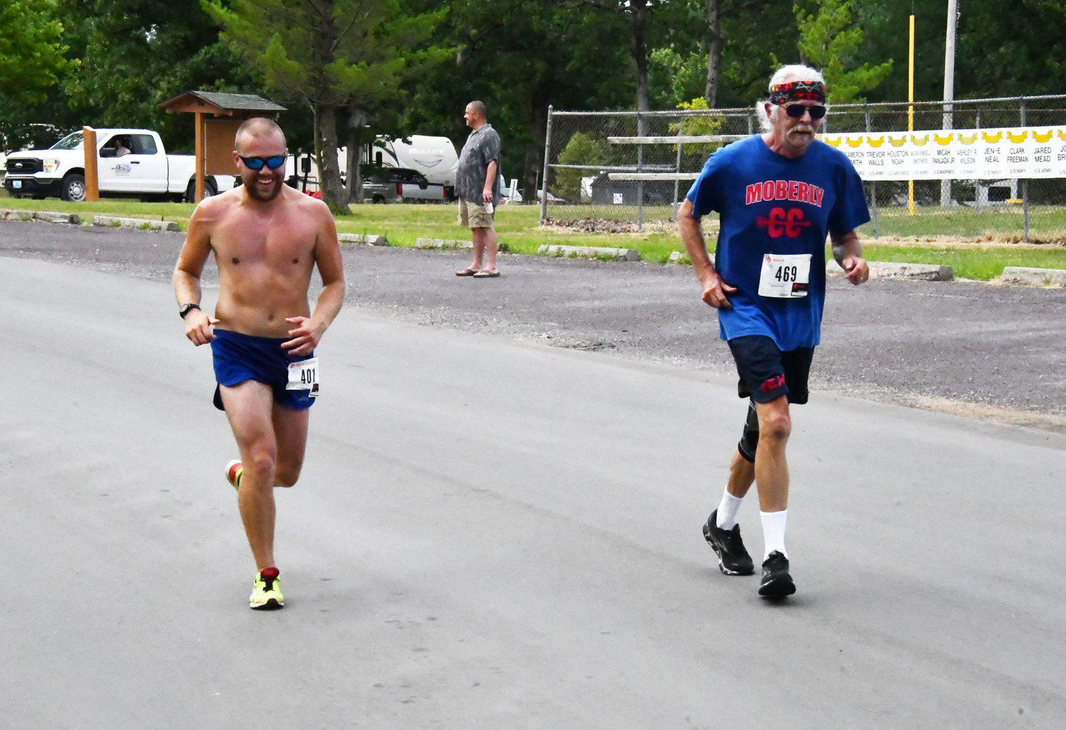 Overall race winner Daniel Hunsaker, left, runs alongside event organizer Gregory Carroll.