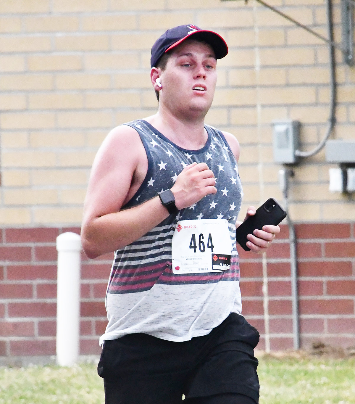 Adam Fincher wore a patriotic tank top while running in the Independence Day 5K run.