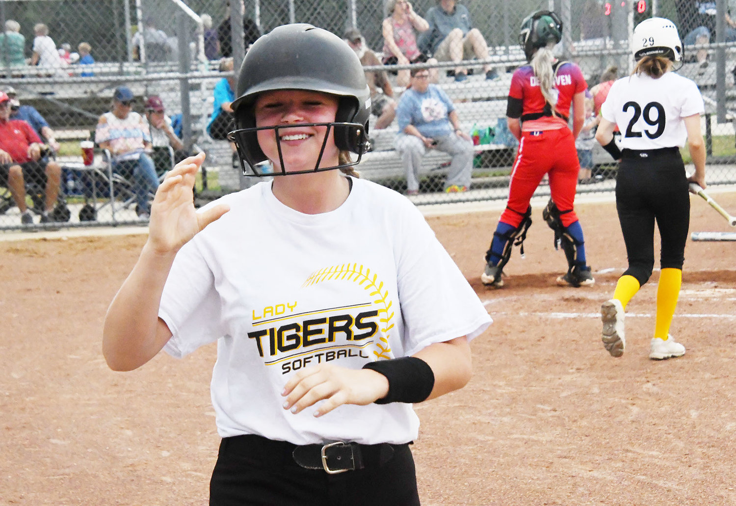 Maddie Seidel of Higbee smiles after scoring a run. Runs came at a premium, with only seven of them in the five-inning game.