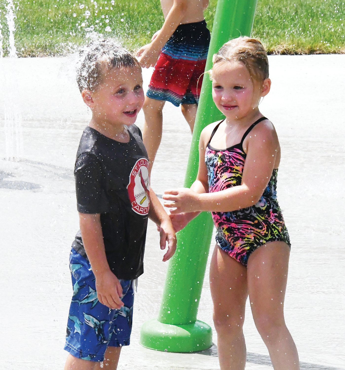 Cole Embree and Emmie Embree enjoy a water feature at the new Tannehill Park Splash Pad on Friday, July 8.