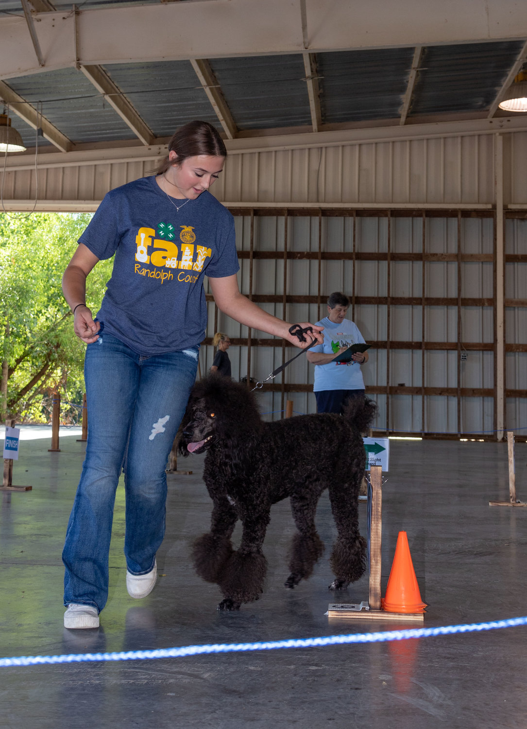 Alexandra Lucas, of Jacksonville, guides Rose through the rally course during the Randolph County Fair dog show Sunday at Riley Pavilion in Rothwell Park.