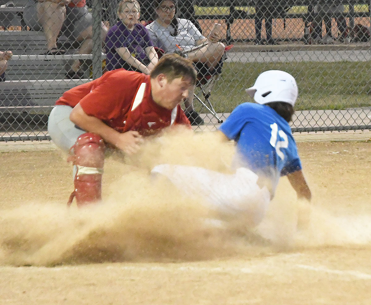 The Bombers' Kyler Fanning is safe at home despite the tag from catcher Nate Straub.