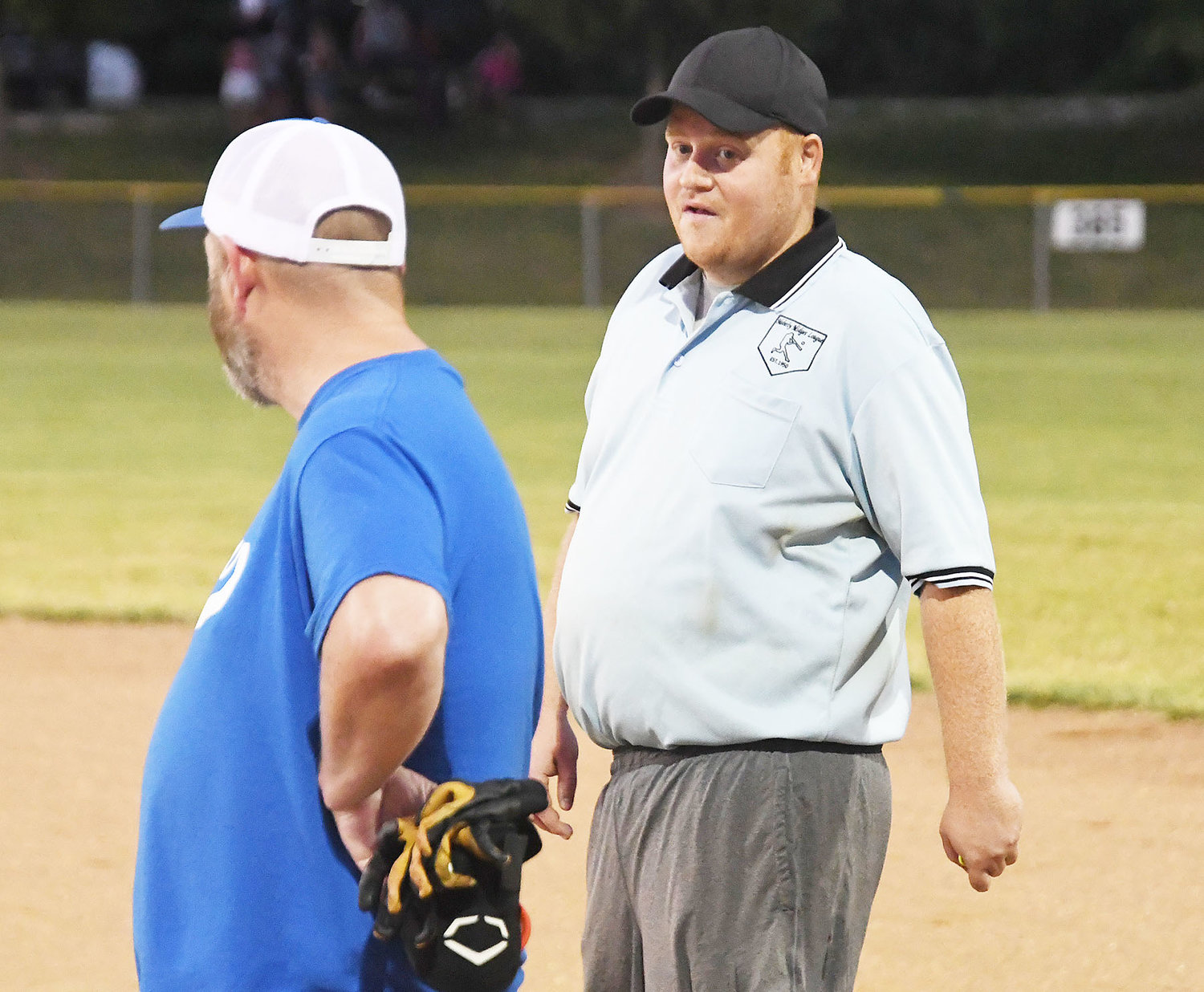 Bombers' assistant coach Steve Wilson shares a moment with infield umpire Calvin Huntsman.