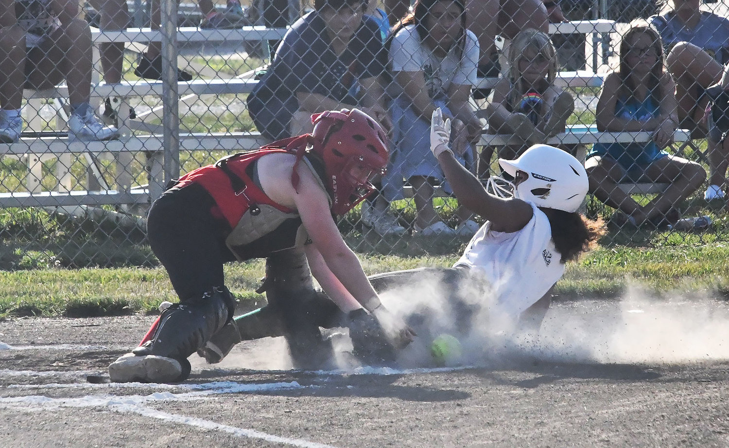 Jaelyn Miller tries to slide into home during the first inning. Miller was called out on the play. Base running is one of the skills players work on, especially during summer scrimmages.