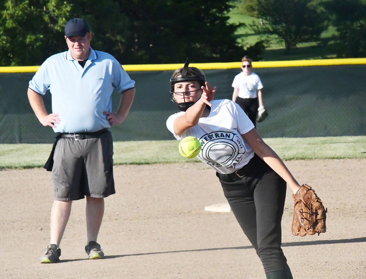 Westran pitcher Kyleigh Carroll throws toward home plate during the first scrimmage as umpire Calvin Huntsman looks on at left.