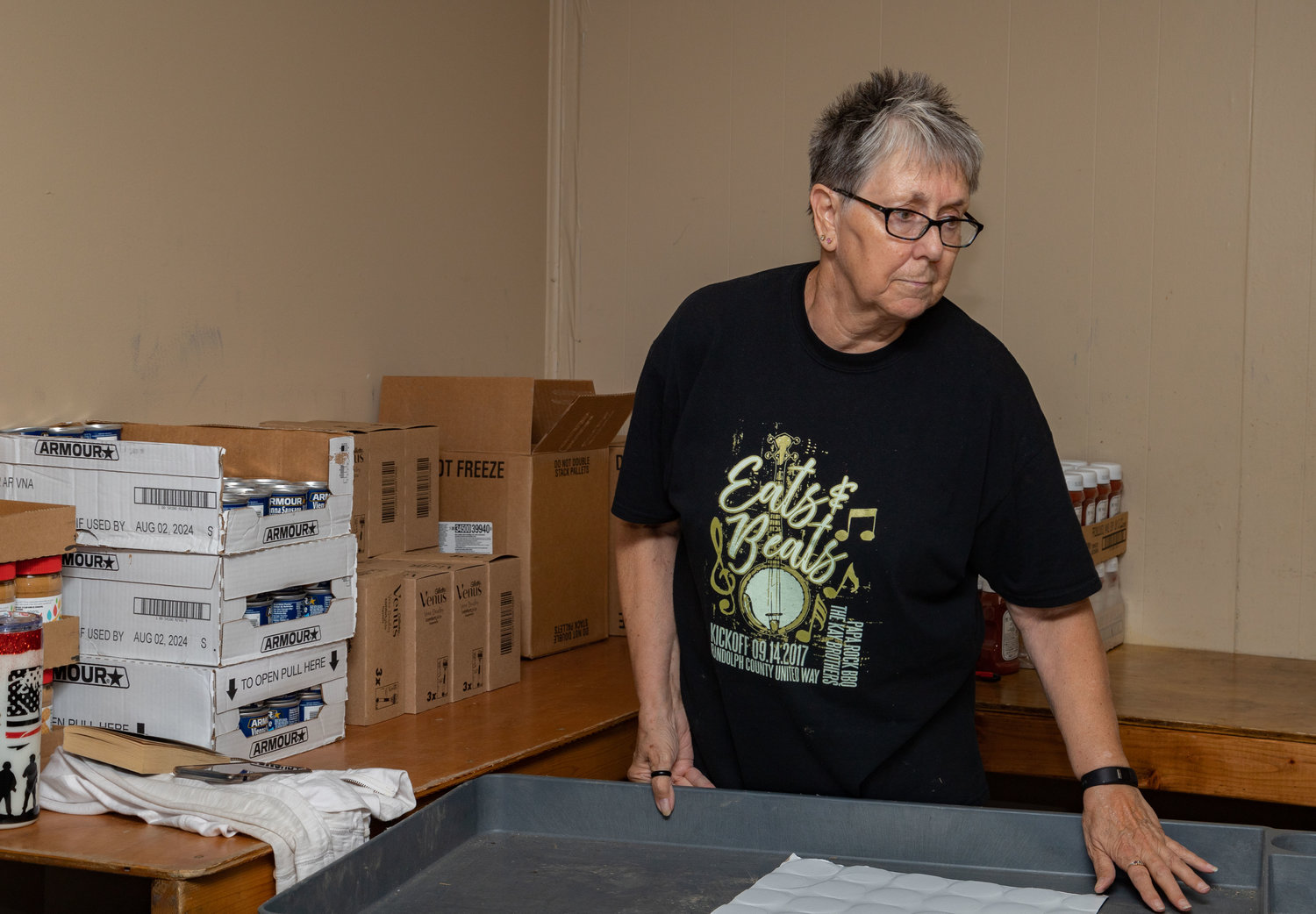 Lynne Taylor prepares for another food order Wednesday at the Christos Center in Moberly. Boxes are packed as cars pull up to the curb.