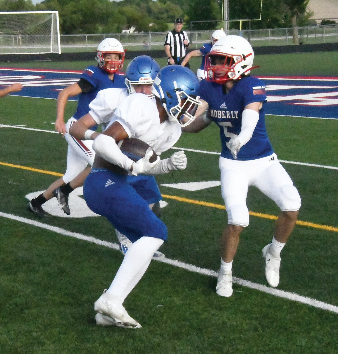 Moberly defender Brett Gelina prepares to tackle a player from Boonville.