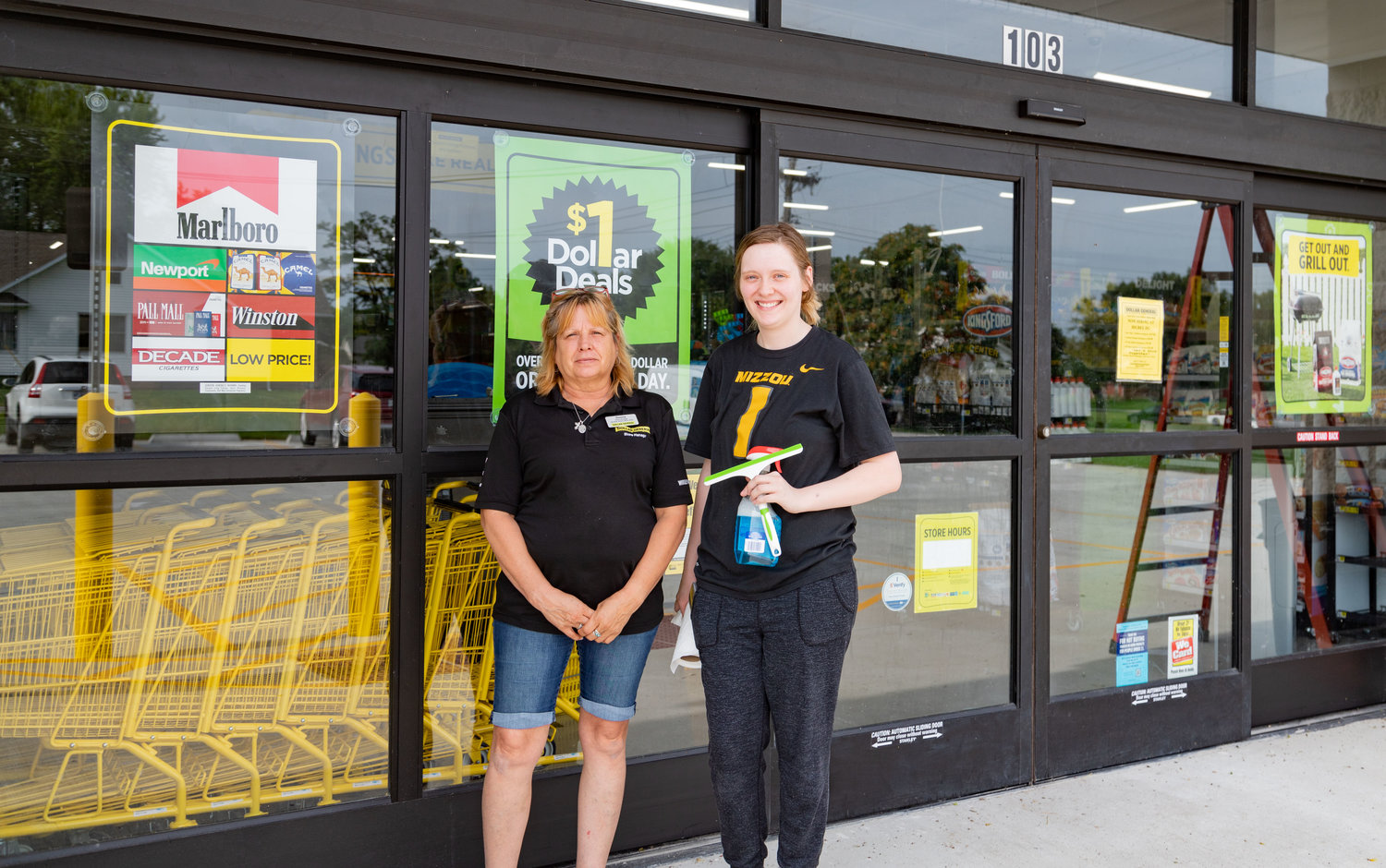 Store manager Donna Clark and employee Kelsey Harold stand outside the Dollar General in Higbee Sunday, what was supposed to be opening day.