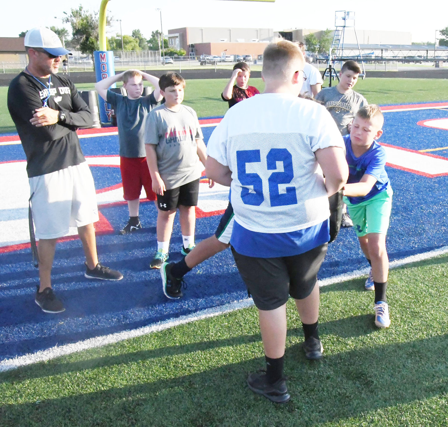 Moberly High School head football coach Cody McDowell worked mainly with the offensive linemen during drills, teaching them the Spartan way.
