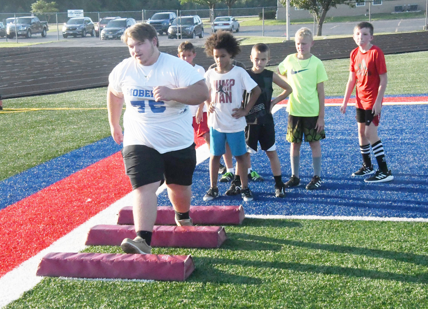Moberly High School defensive lineman Christian Wolfe, a junior, served as one of the player instructors.