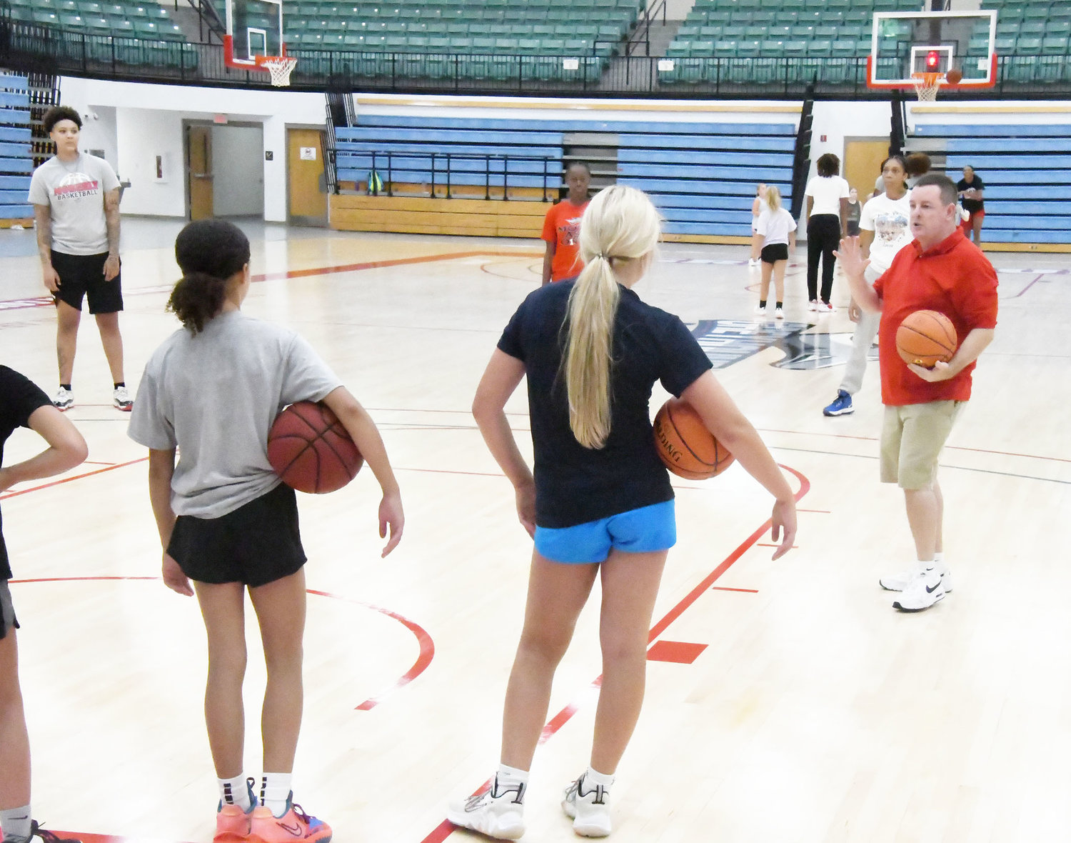 New Moberly Area Community College assistant women's basketball coach Chris Harris instructs campers during the morning session.