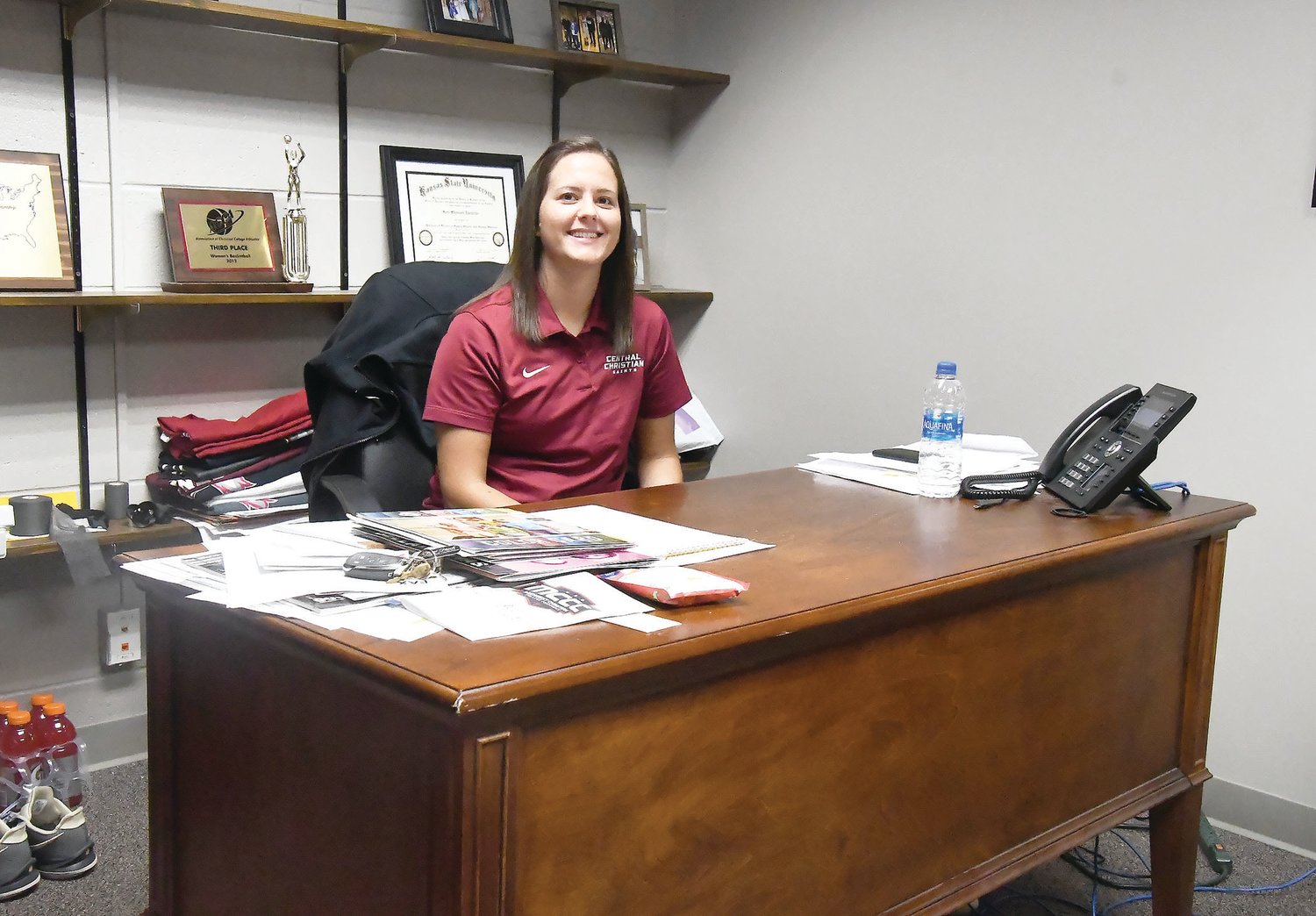Kori Zarzutzki smiles inside her office at Pelfrey Hall on the Central Christian College of The Bible campus. Zarzutzki was recently named the small college’s athletic director. She also is entering her second year as the head women’s basketball coach.