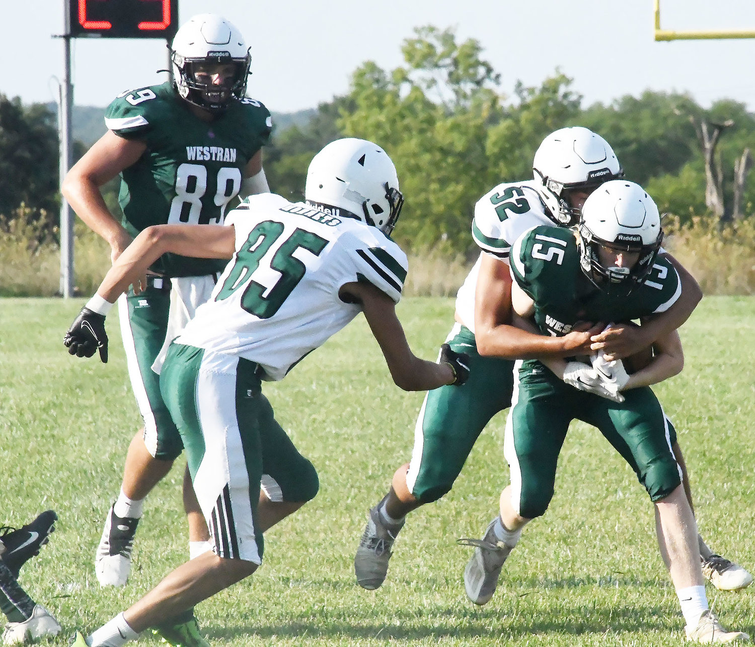 Westran High School’s Sam Harlan (15) is tackled by Blake Williams (52) during the green-and-white scrimmage on Saturday morning at the high school stadium. The Hornets’ will compete in a jamboree this Friday, Aug. 19. Read more on Page 7 of this edition of the Monitor-Index.