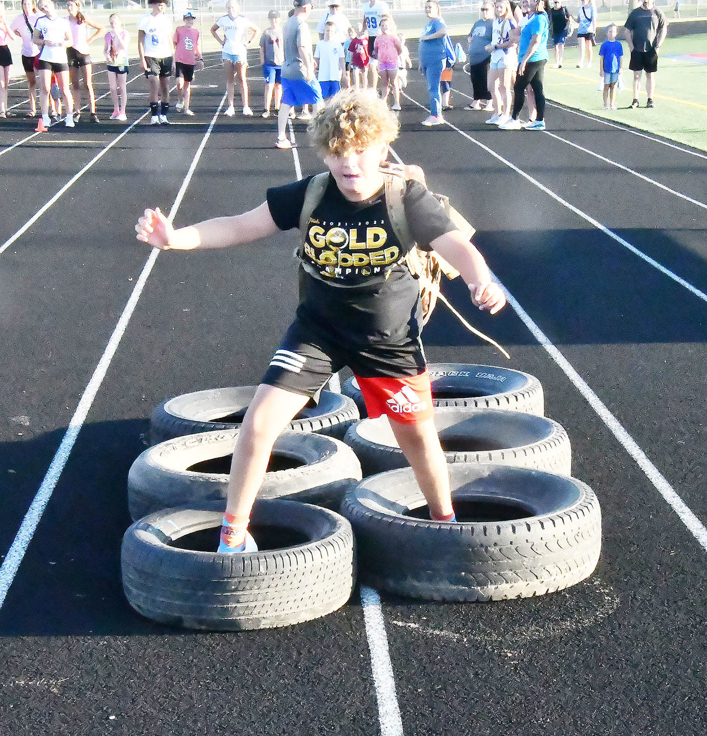 Jackson Link runs through tires during the JROTC obstacle course competition. Link is a student in the Moberly school district.