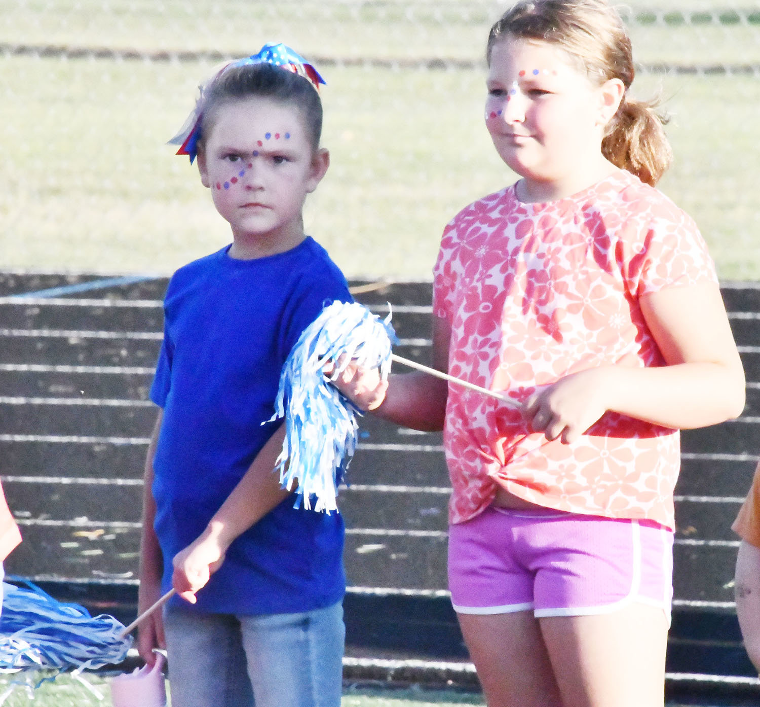 Two girls received face paint and poms during "Meet The Spartans."