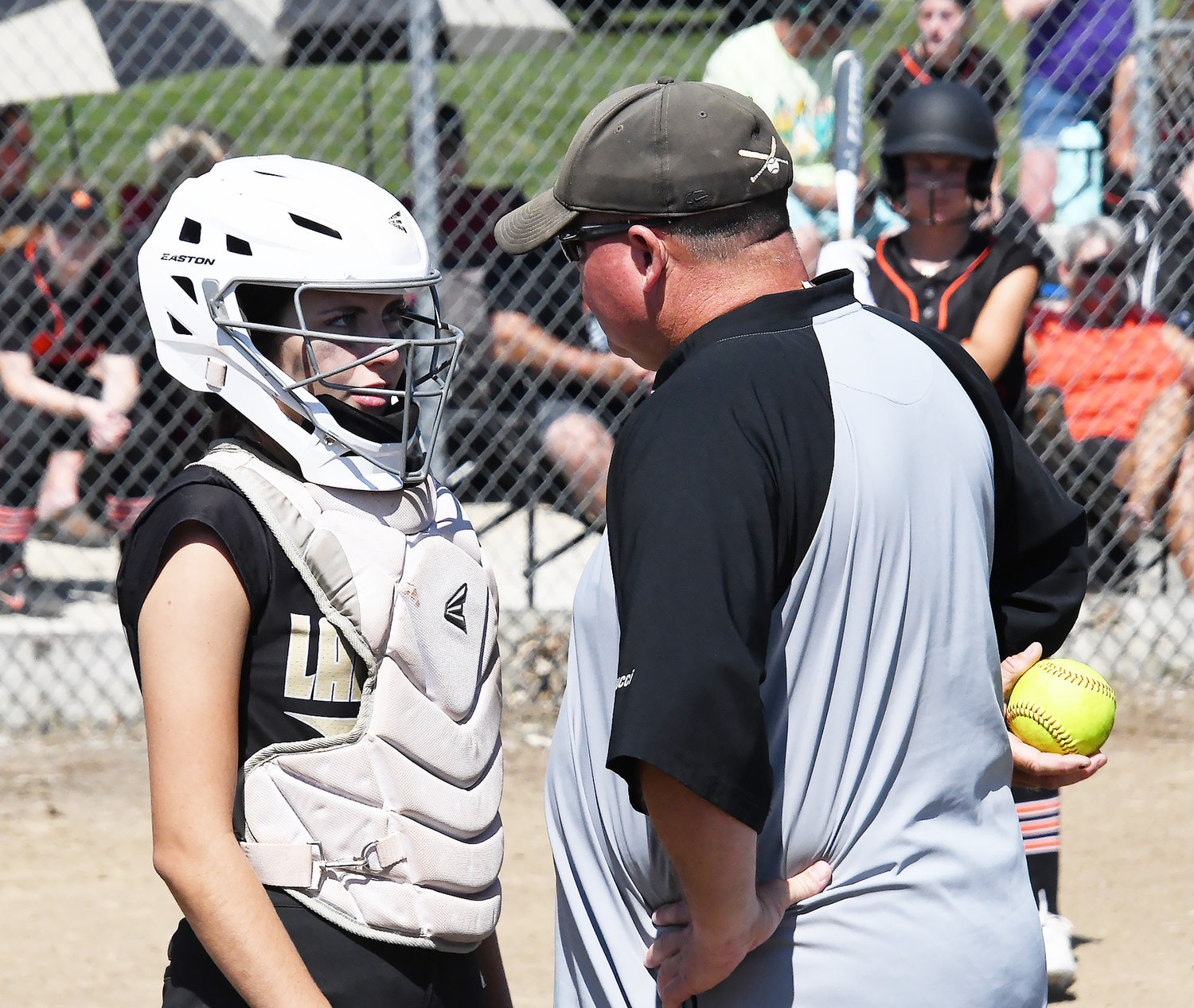 Cairo catcher Darcy Pierce listens to Bearcats' head coach Brian Winkler during a jamboree game against Macon.