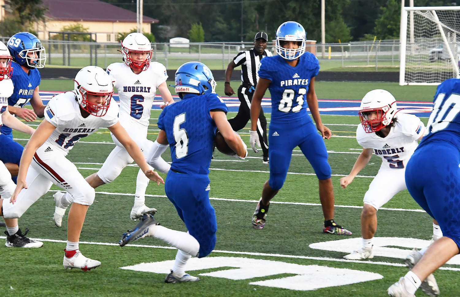 From left, Moberly's Levi Moran, Nick Kessler and Brett Gelina surround a Boonville ball carrier during Friday's scrimmage.