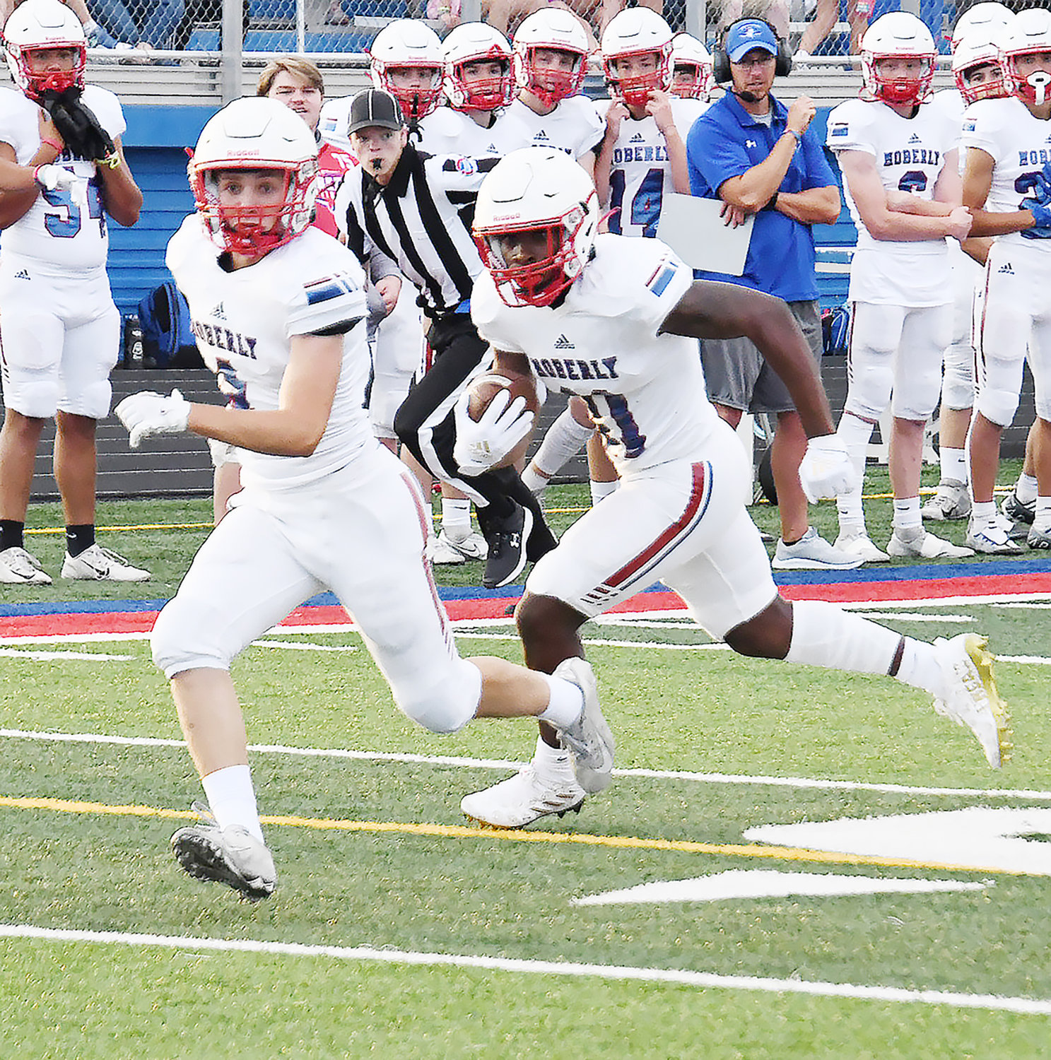 Moberly's Hunter Boots (4) prepares for a lead block while Derieus Wallace runs for a Spartan touchdown.