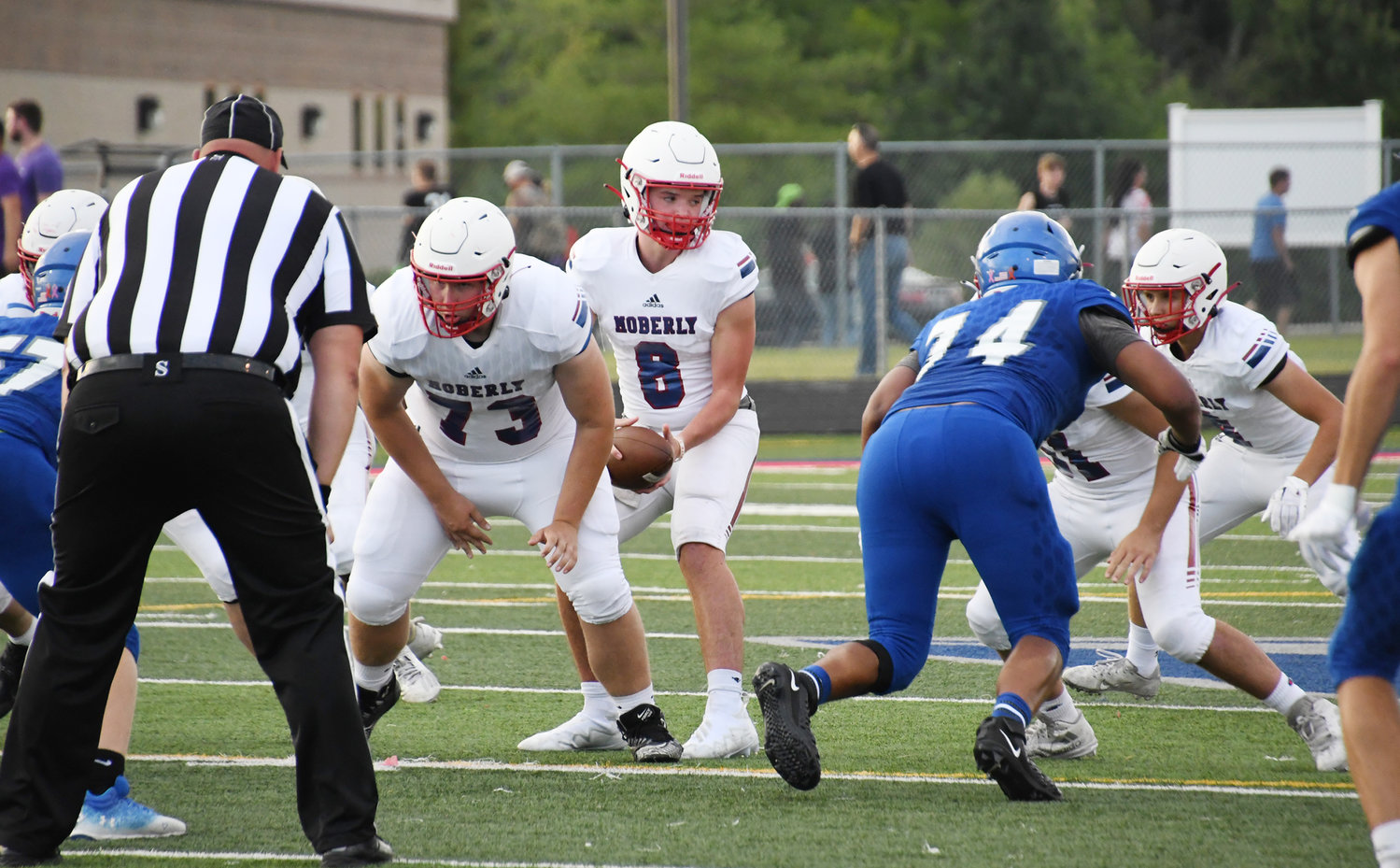 Moberly senior starting quarterback Collin Huffman starts the play, preparing to hand off to Hunter Boots.