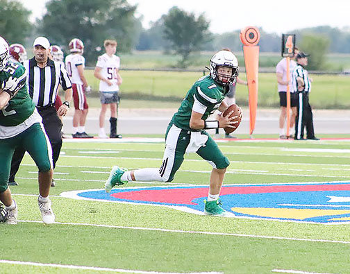 Cooper Harvey (7) sprints out to the left looking to pass, or run. Harvey has been named the Hornets' starting quarterback by head coach Aaron O'Laughlin.
