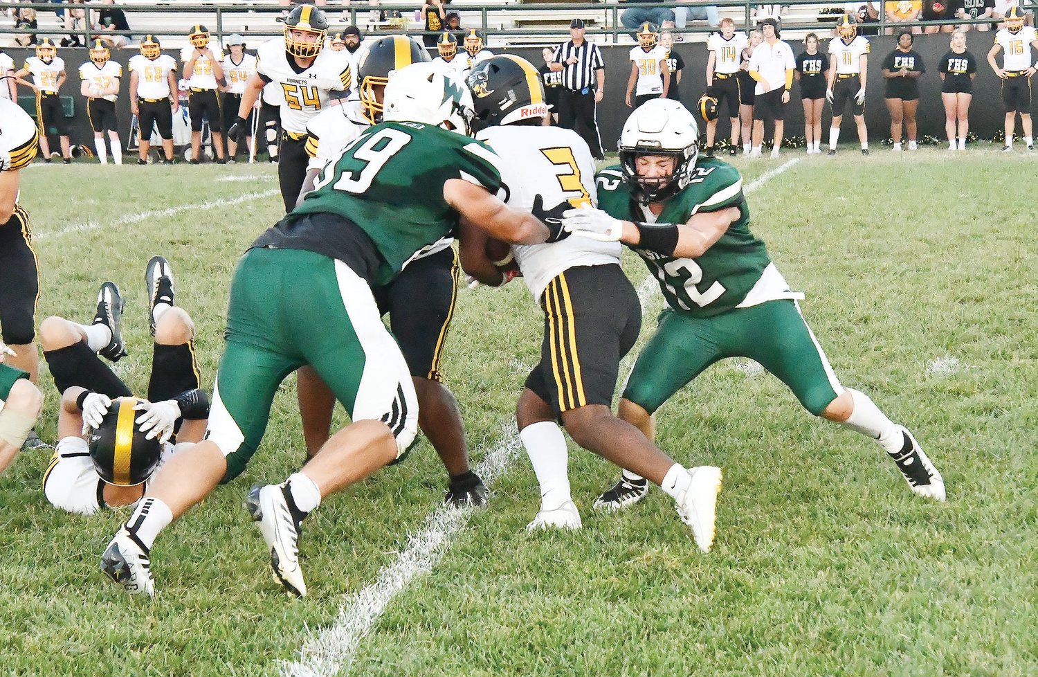 Westran's Langden Kitchen (89) and Brady Hollman (12) team up for a tackle during the first half of Friday's game.