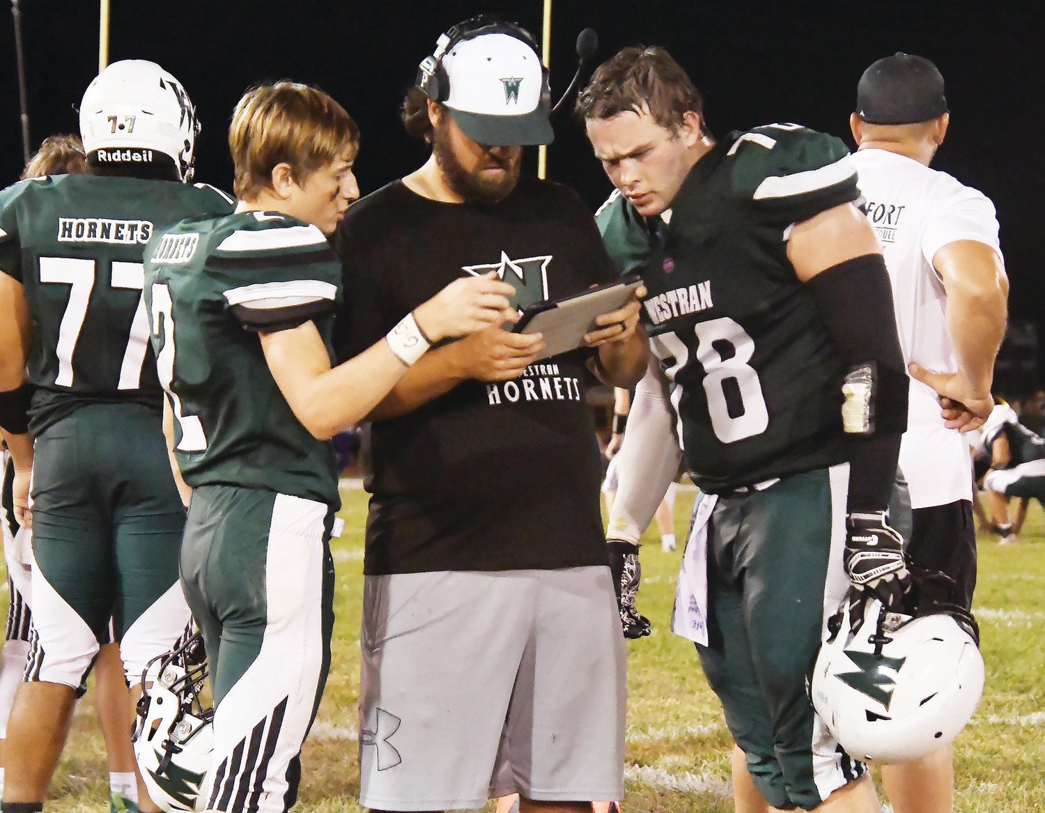 Westran football players Nate Kribbs (2) and Brenin Howell (78) cover assignments with assistant coach Jordan Saah, a first-year coach who most recently served in the same capacity in Louisiana.