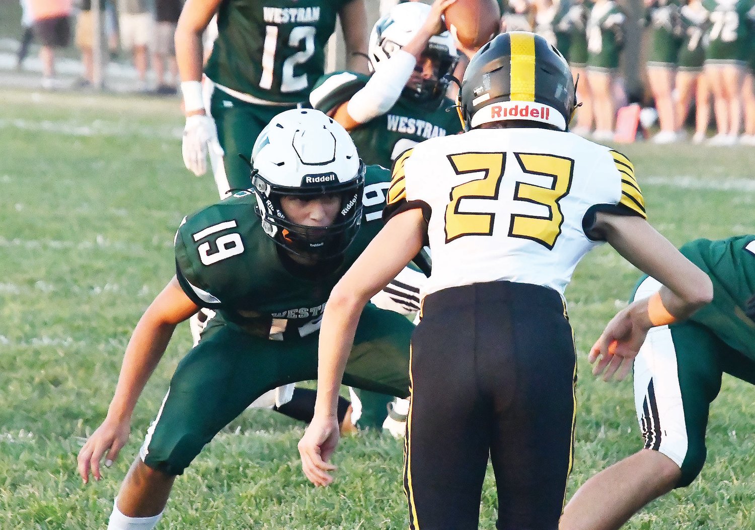 Westran football player Gage Adler (19) looks to block while Brady Hollman attempts an extra-point kick during the first quarter of Friday's game.