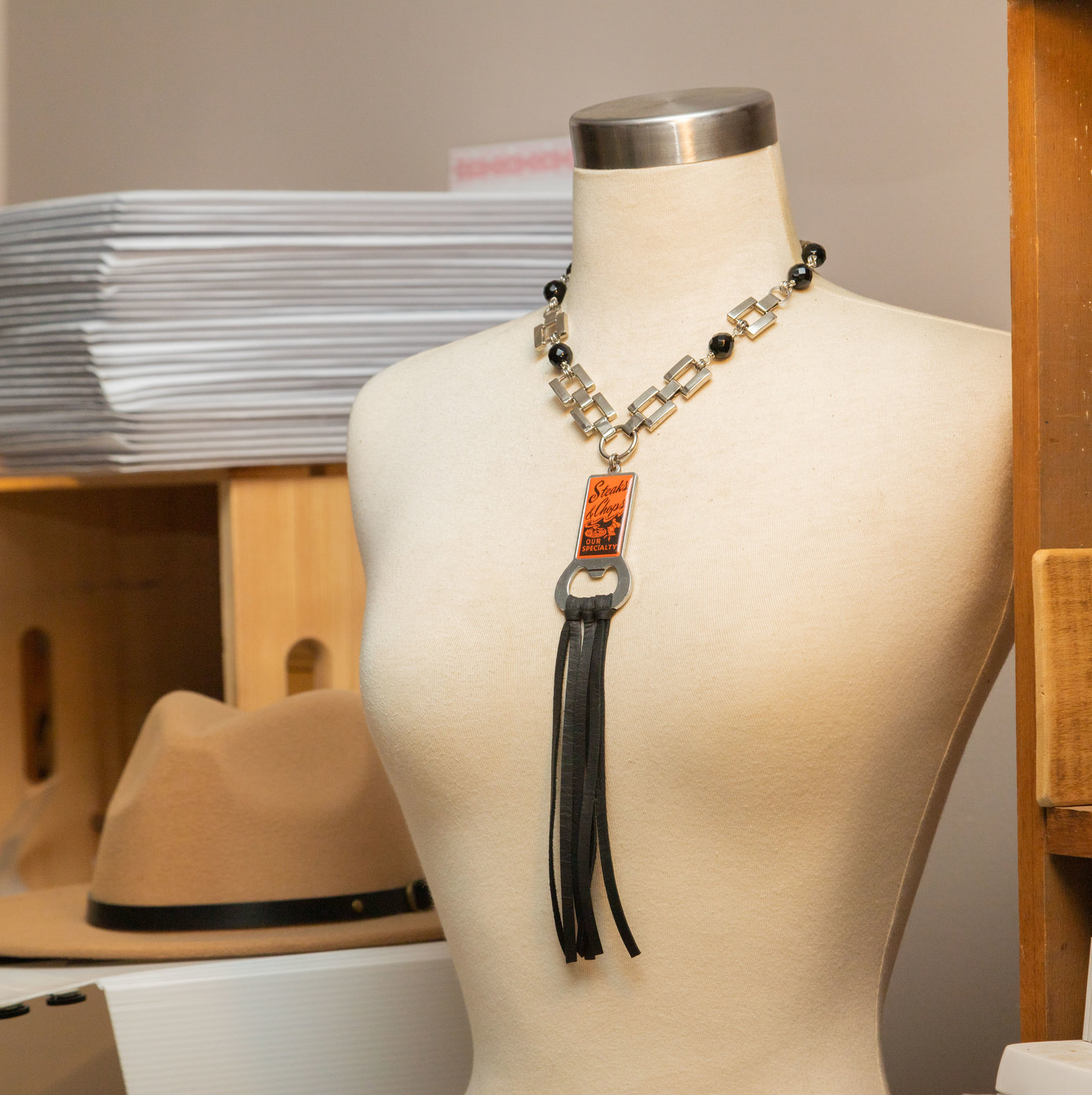 A belt chain and some leather turn a bottle opener into a necklace. Anne Jansen recycles small items into wearable art for her jewelry line, Key of A.
