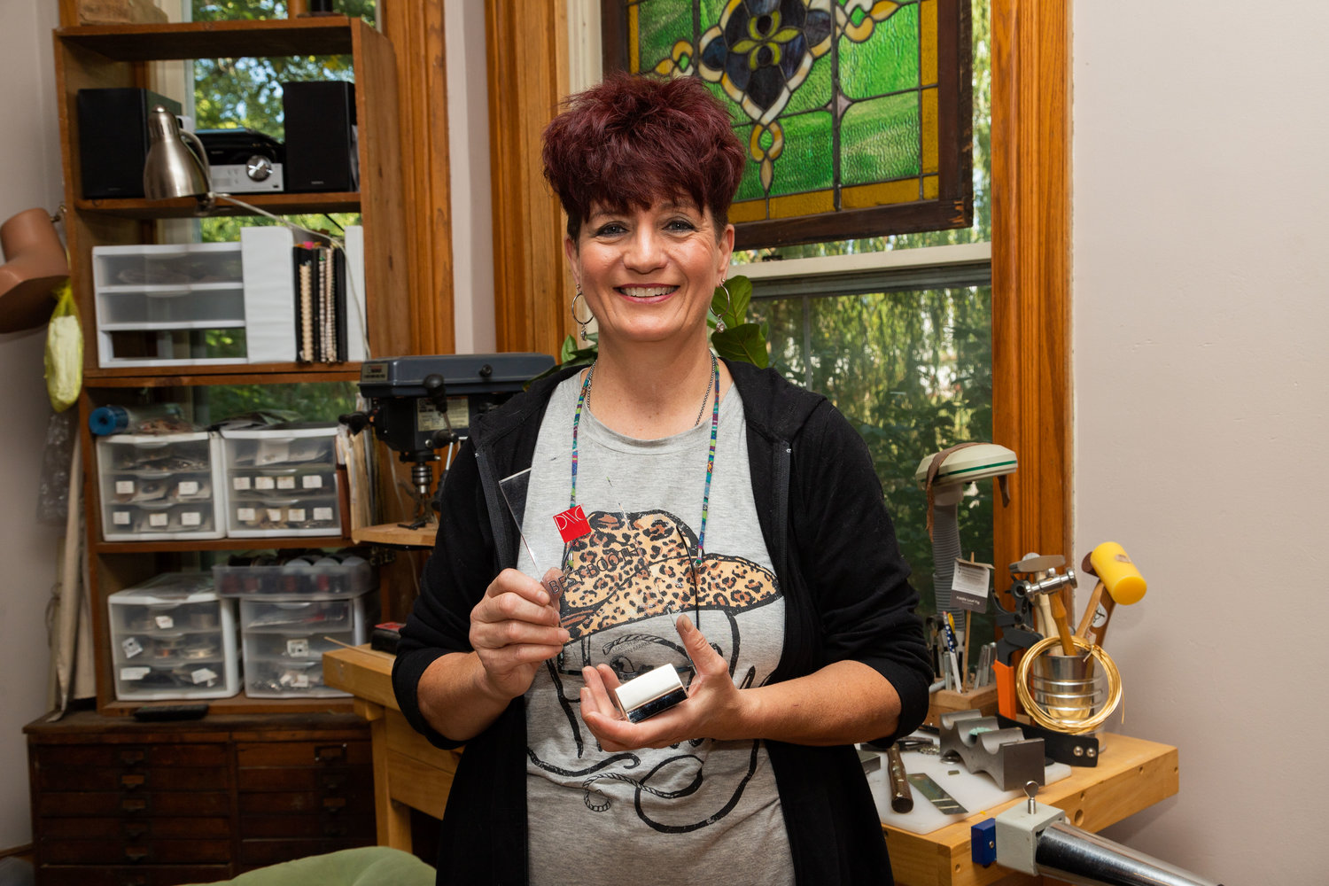 In the parlor of her historical home in Moberly, Anne Jansen shows an award she received for best booth on the 12th floor at a show in Dallas Western Market in 2014. Jansen created a western space from which to sell her Sureshot brand of bullet jewelry.