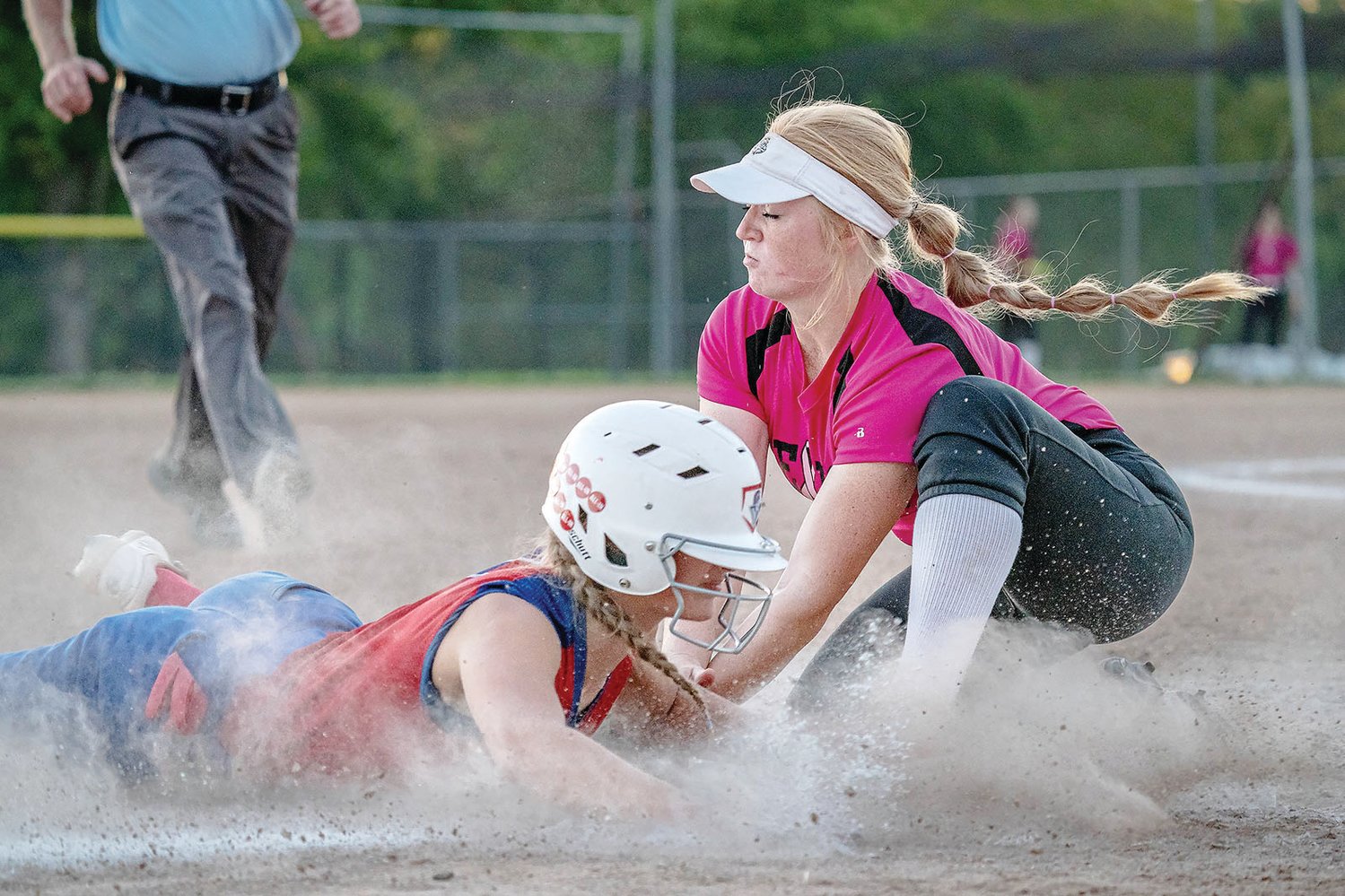 Moberly’s Chloe Ferguson slides into third base safely before Mexico third baseman Abby Bellamy has a chance to apply the tag during Tuesday’s North Central Missouri Conference game at Gallop Field in Mexico. The Spartans suffered a 12-11 loss to the Bulldogs, snapping a four-game winning streak.