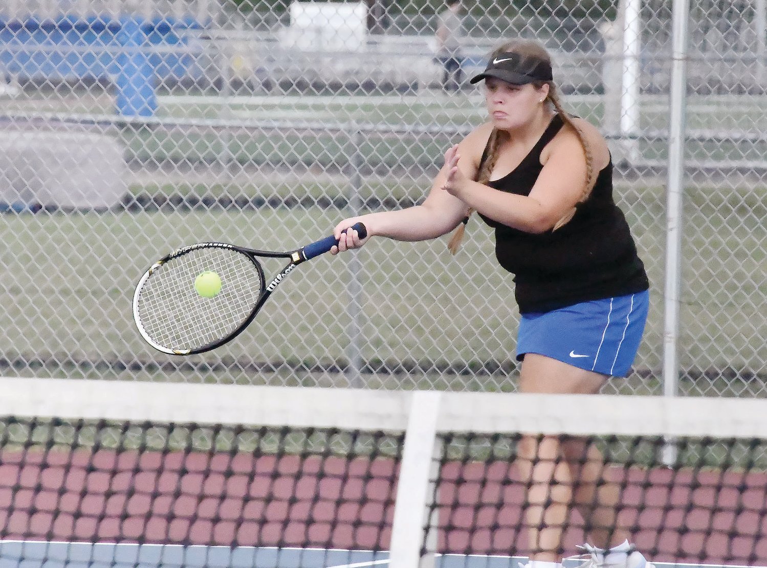 Moberly High School senior Kristyn Kruse (black tank top) returns the ball to Boonville before rain ultimately canceled Wednesday’s dual versus Boonville. Kruse was one of four senior Spartans honored before the match.