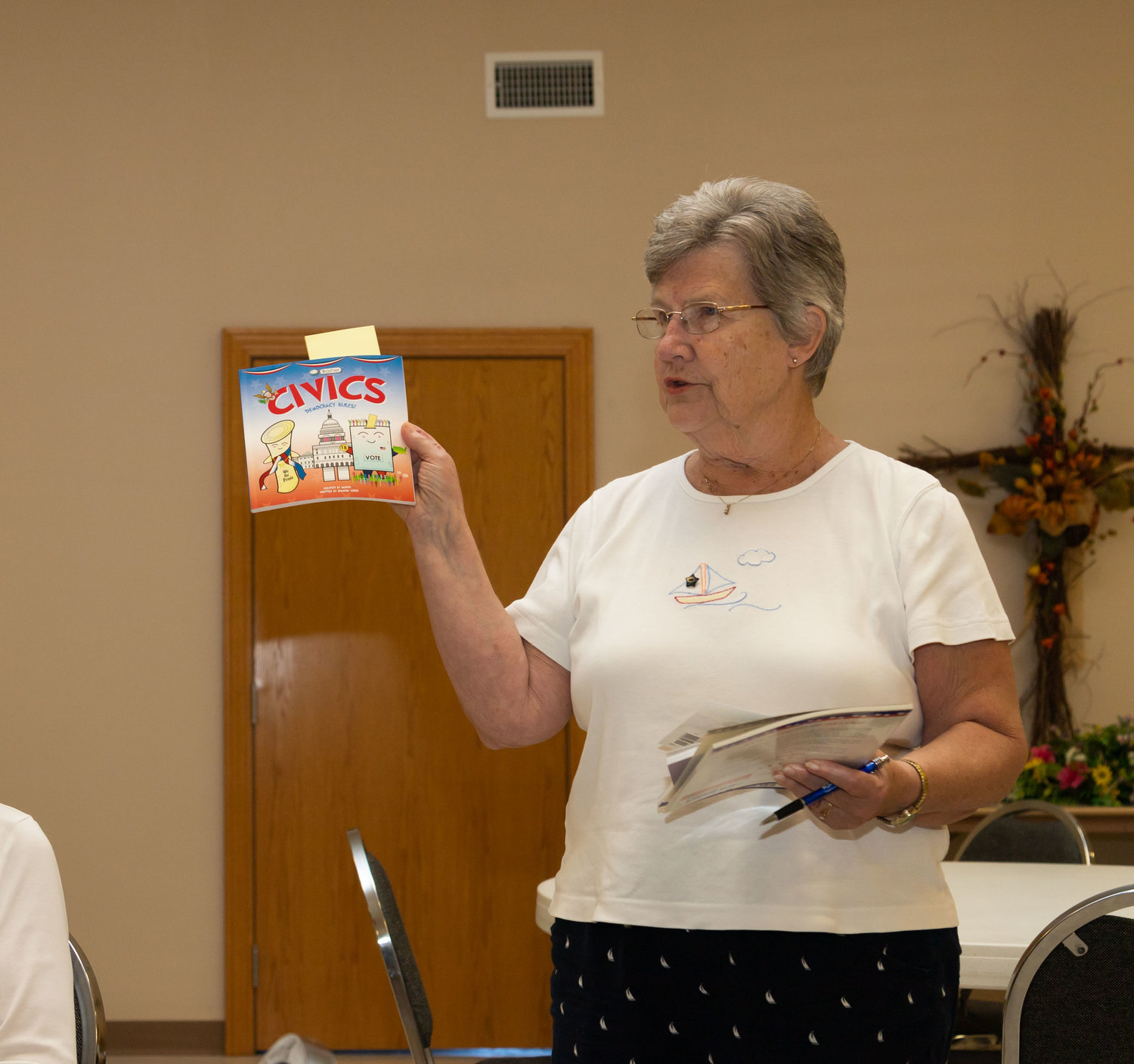 Joyce Van Houten shows the Margaret Miller Chapter of the Daughters of the American Revolution the books they will be donating to local schools during Constitution Week.