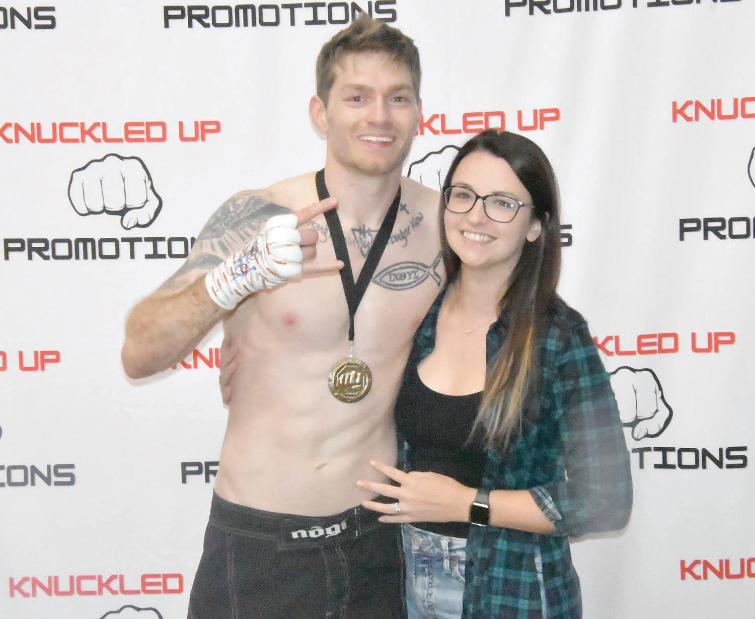 Mixed martial arts fighter Coty Penn, along with his wife Bethany, pose after Coty won his fight on a split decision. The bout was competitive, but Penn did enough to swing two judges' cards in his favor.