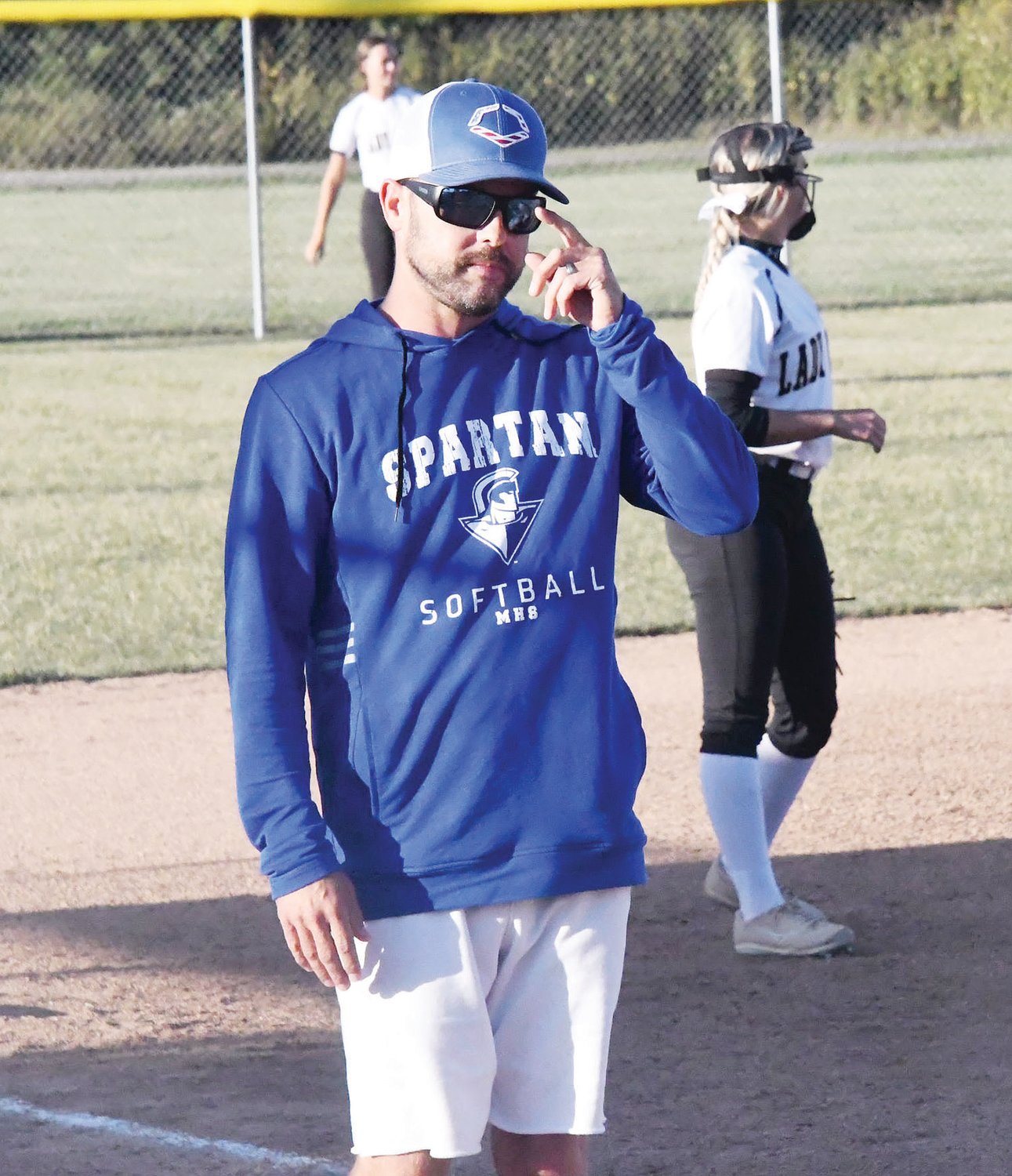 Moberly High School softball coach Drew Hunt, here giving a sign during a game versus Cairo from Sept. 27, credited the Spartan girls for never quitting on the season. They are now at the .500 mark after starting the campaign 2-9.