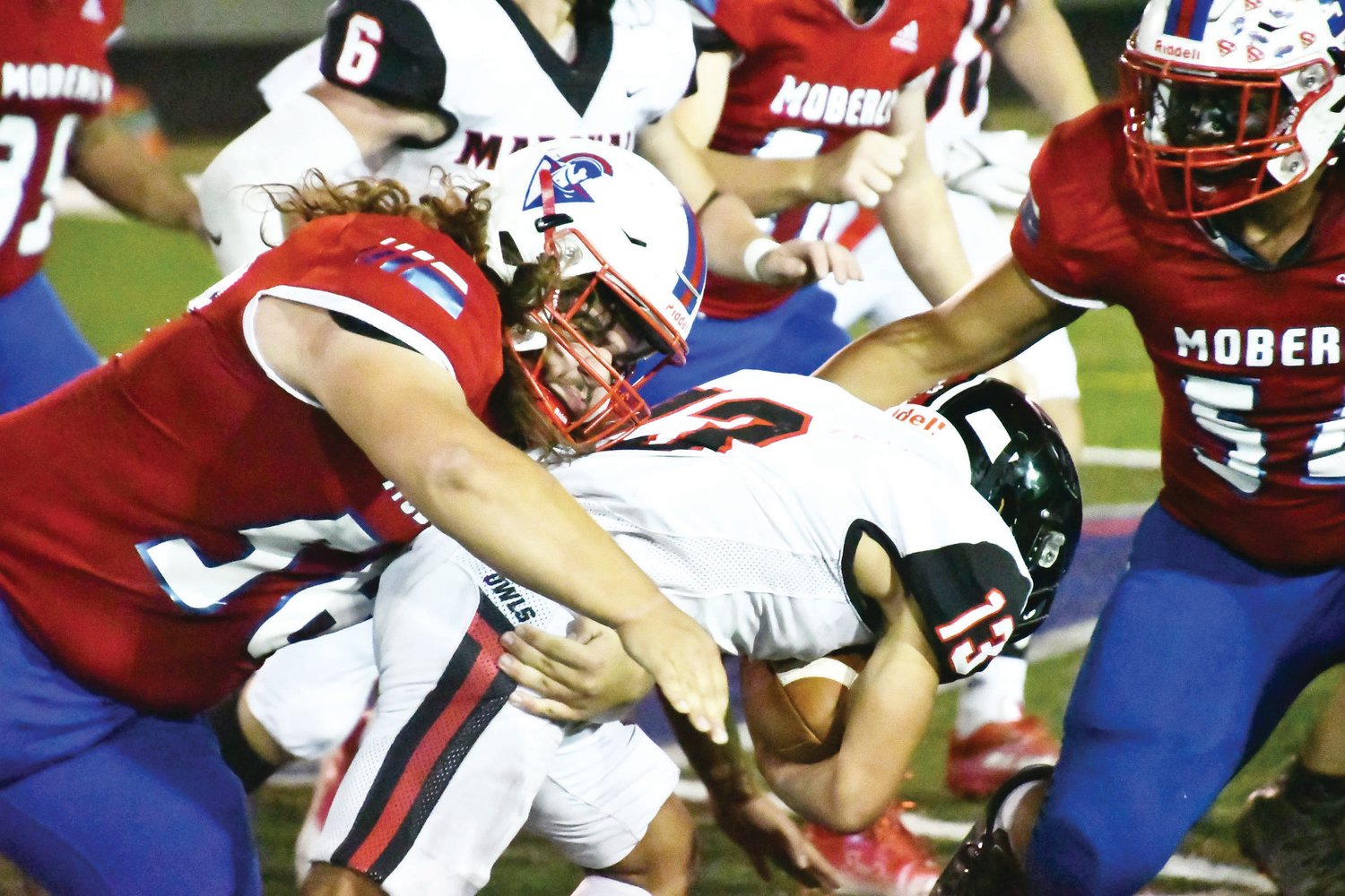 Moberly High School's Rick Huff (58) tackles Marshall running back Kamryn Workcuff during Friday night's North Central Missouri Conference football game at Dr. Larry K. Noel Spartan Stadium. Huff racked up 16 tackle points, including six solo stops; however, the Spartans suffered a 17-7 defeat at Homecoming.