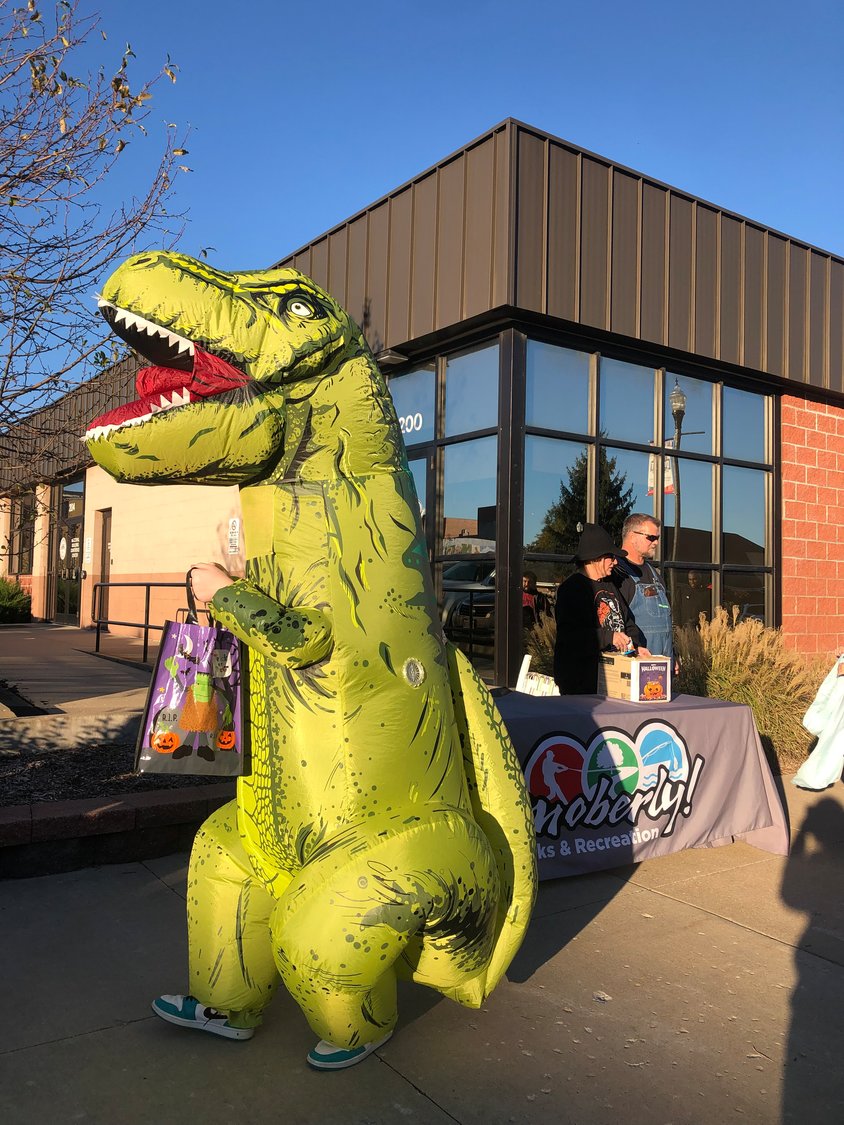 A tyrannosaurus Rex hunts candy on Reed Street in Moberly during a previous Trick-or-Treat Trail.