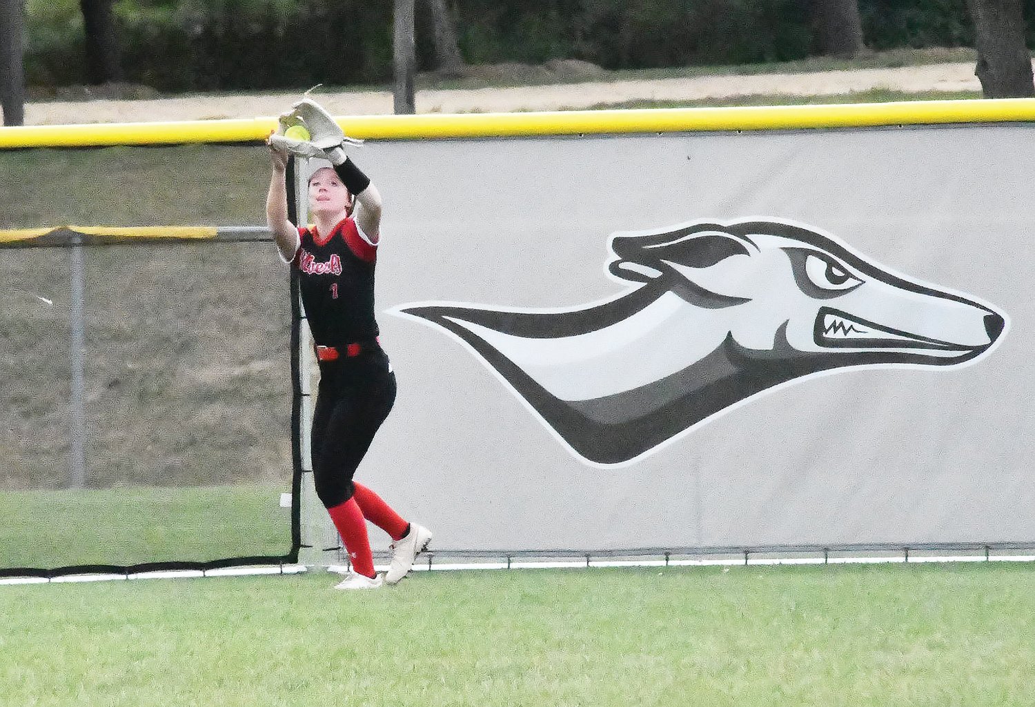 Harper Rollins makes a catch in center field, during last Saturday's doubleheader, in front of recently installed temporary fencing at Hils Athletic Complex.