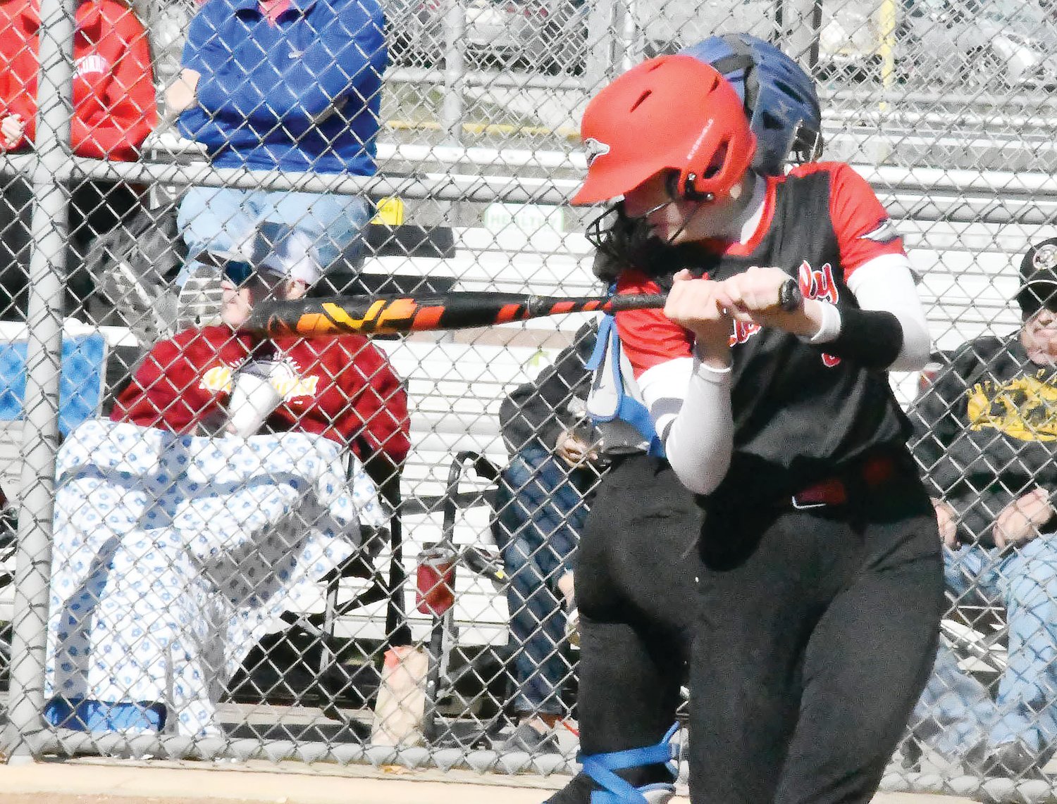 Mackenzie Roofener takes practice cuts before returning to the batter's box during her plate appearance.