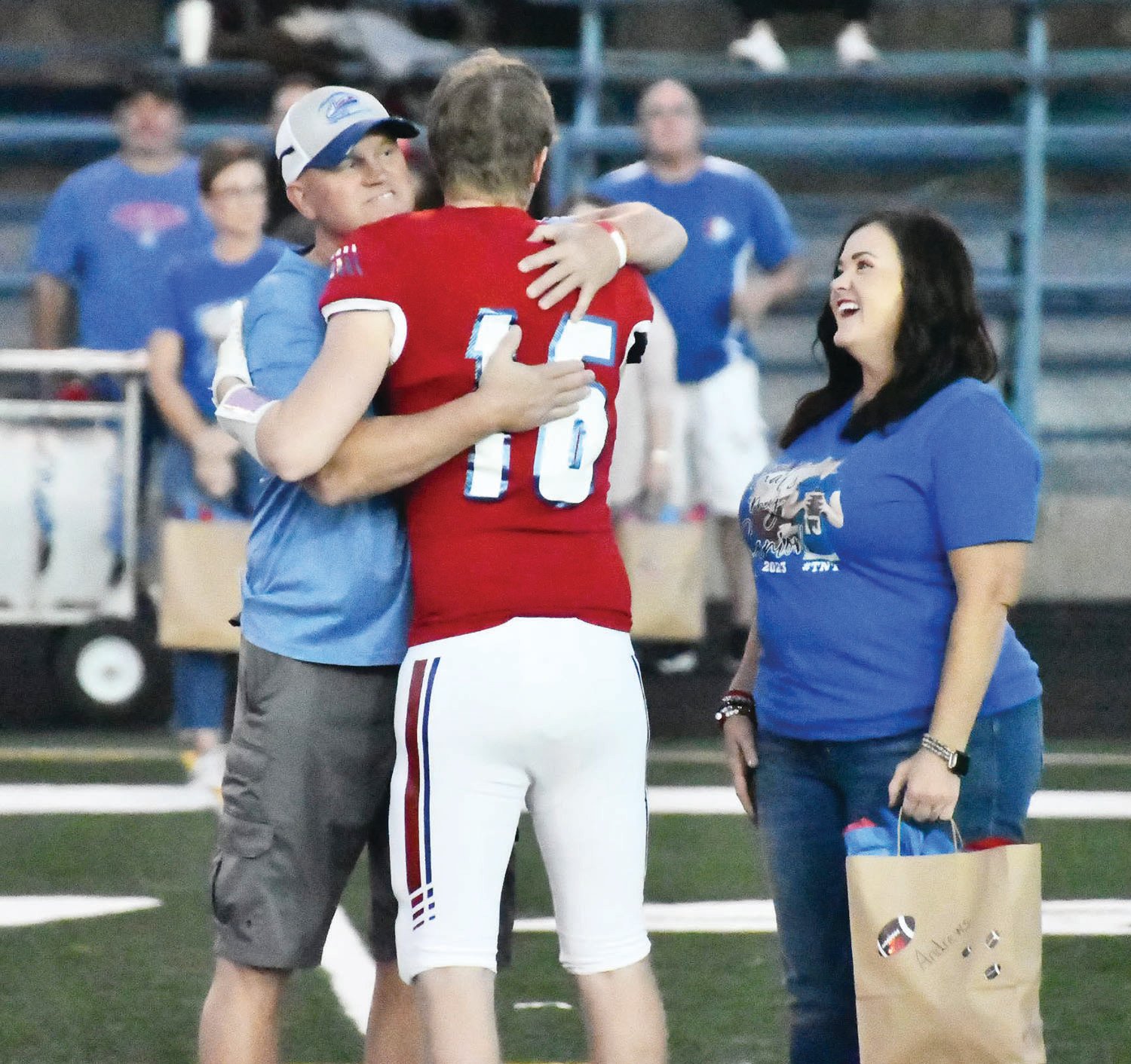 Stacy Andrews and Troyann Andrews share a moment with their son, Landon, during pregame Senior Night activities at Dr. Larry K. Noel Spartan Stadium on Friday, Oct. 21.