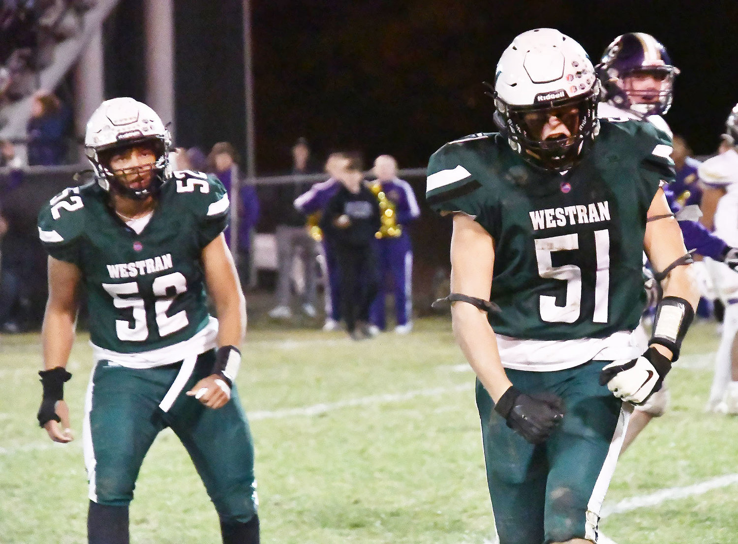 Blake Williams (52) watches Brady Hollman's reaction after Hollman sacked Ryan Binder for an eight-yard loss late in Thursday's Class 1 District 6 first-round game between Westran and Salisbury. The Hornets nipped the Panthers, 16-14.